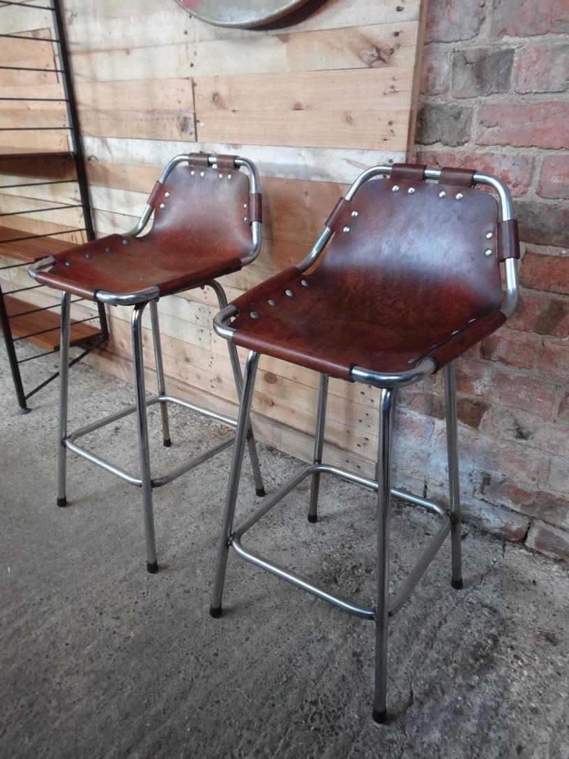 Stunning set of two stools, designer Charlotte Perriand used these in the Ski Resort Les Arcs, circa 1960. These stools were commissioned to be made by Cassina, one of the best Italian furniture maker’s very nice chrome tubular frame with thick