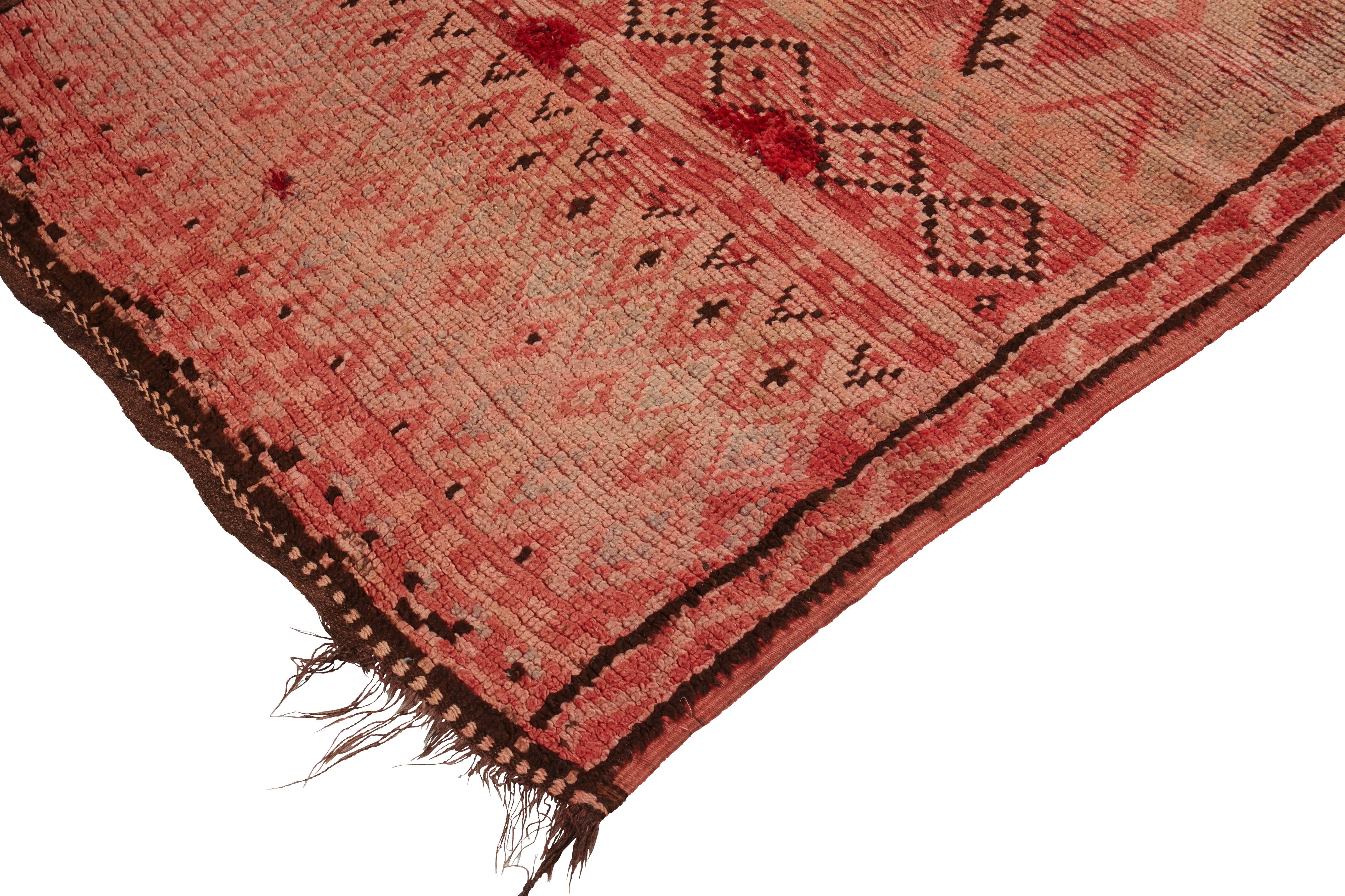 Beni M'Guild rug. 
Middle Atlas Mountains,
Morocco,
mid-late 20th century.
Wool, low pile.

Size: 440 x 155cm.

This large runner rug has been hand woven with a short pile of soft wool in varying shades of pink. There is some minor fading