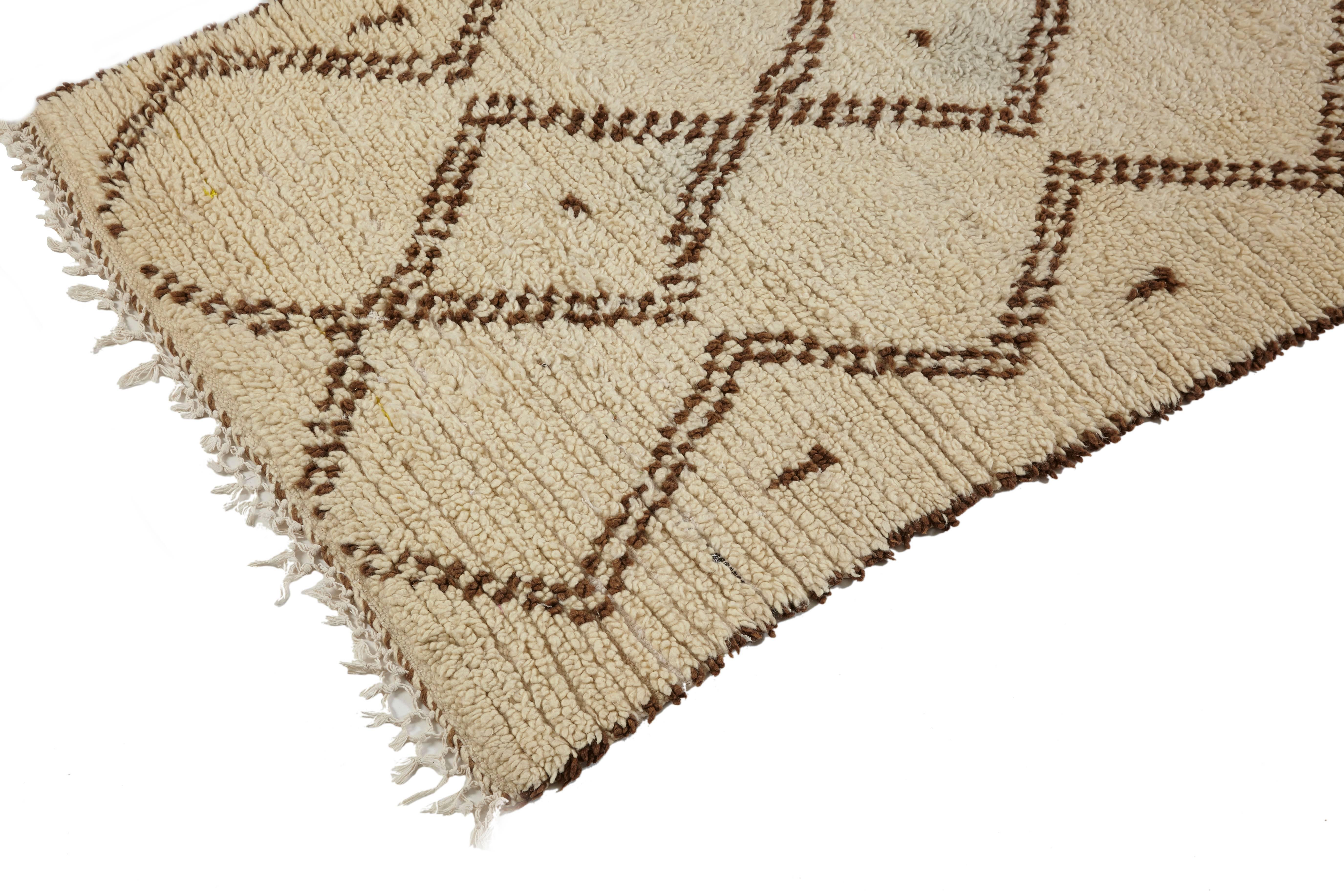 Beni Ouarain runner rug,
Middle Atlas Mountains,
Morocco
Late 20th century,
Wool, medium pile,
Yellow tone to the wool with brown motif

Measures: 355 x 100cm.