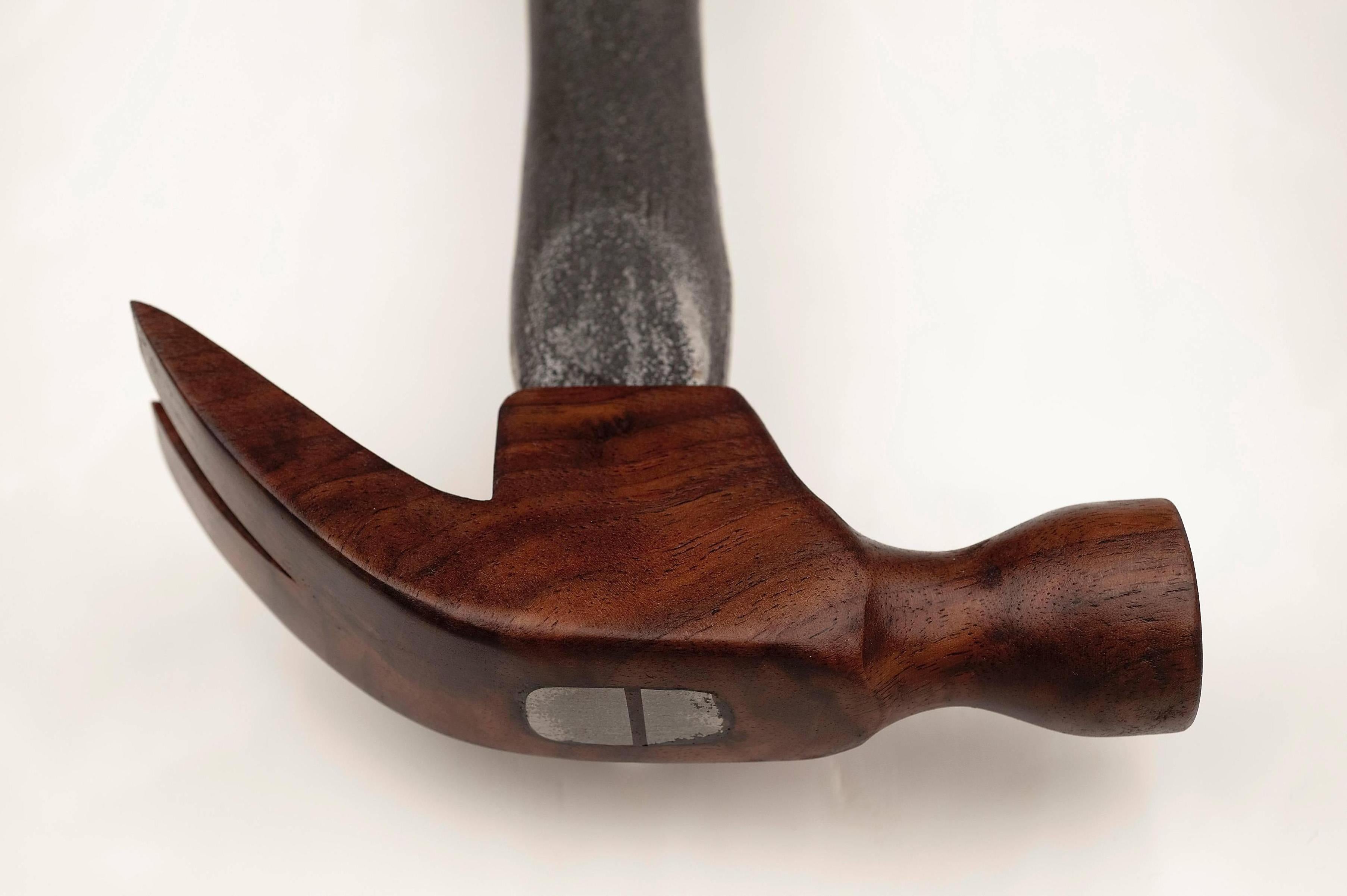 If no other tool resides in one’s home, it is the necessary, the ubiquitous carpenter’s hammer. Hand-carved from a solid piece of Black Walnut from the smooth arc of the forked claw to the hourglass like circular head, the piece culminates in the