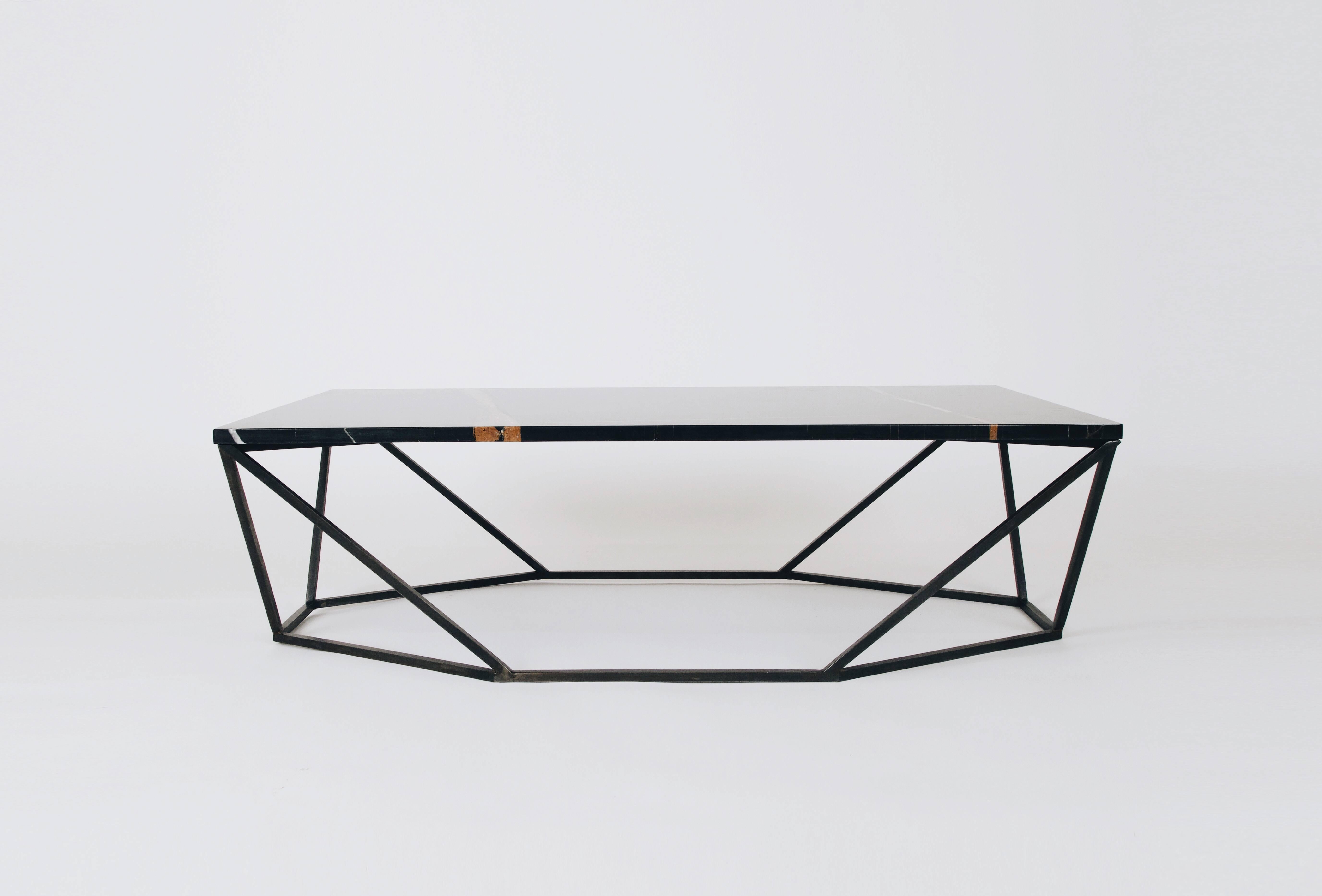 This rich finish combination for the Dusk Coffee Table features a geometric blackened-steel base with a black Nero Durata Mable tabletop. 

The octagon-meets-rectangle shape transforms when viewed from different angles. The dusk coffee table was