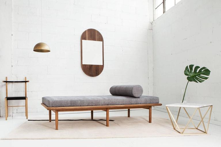 Scandinavian minimalism and luxurious texture come together in this six-legged modern daybed.  The white-oak base is comprised of a rounded-edge frame and distinctively hand-shaped legs, which taper on two sides.  The plush cushion features centered