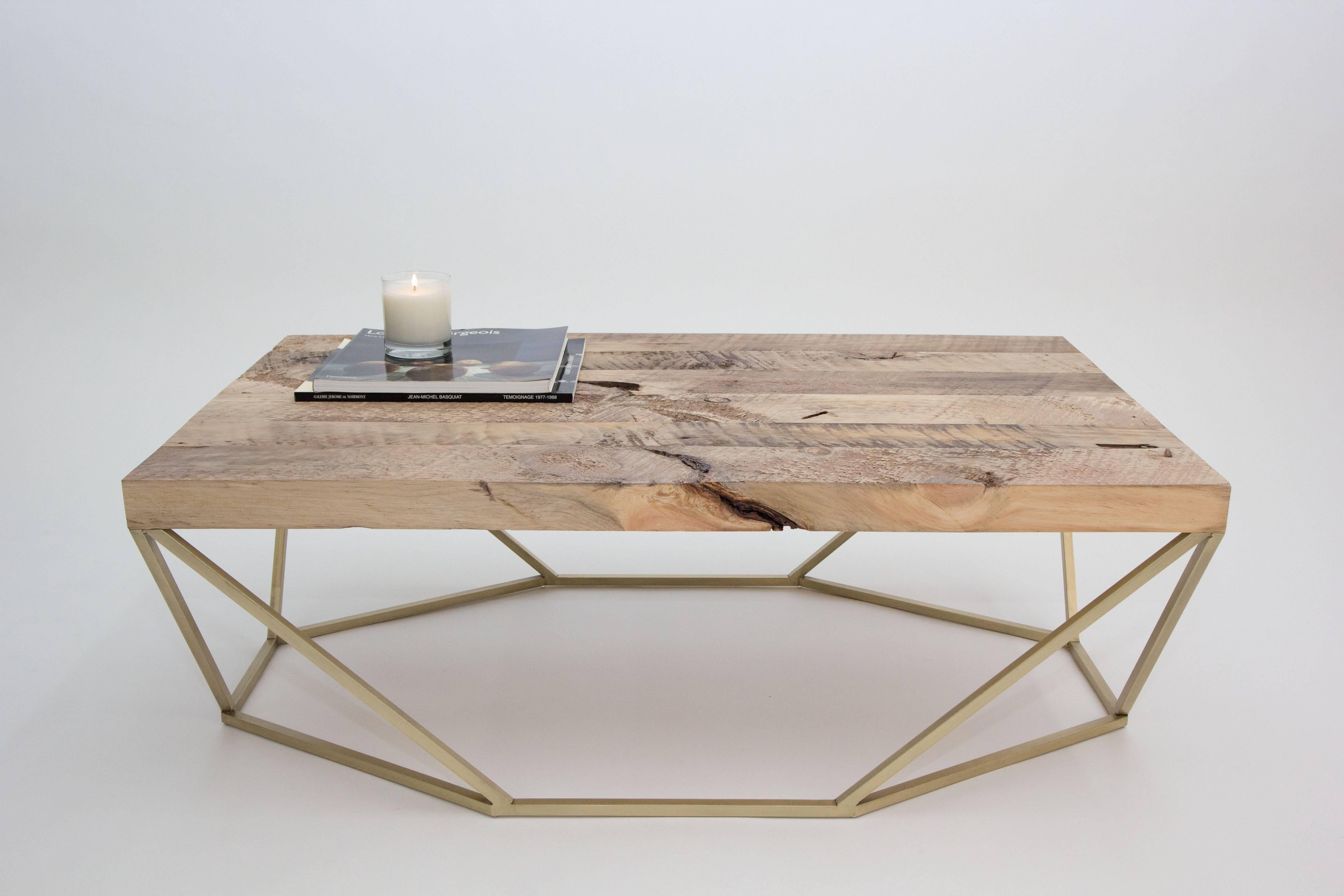 The original finish combination for the dusk coffee table features a geometric solid polished-brass base with a rich salvaged-wood tabletop. 

The octagon-meets-rectangle shape transforms when viewed from different angles. The Dusk Coffee Table