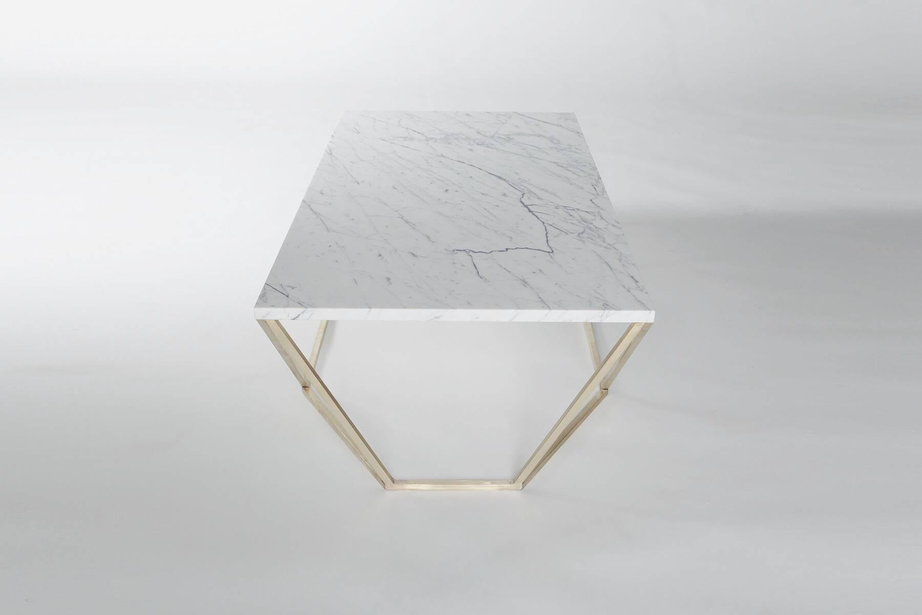 The newest finish combination for the dusk coffee table features a geometric solid brushed-brass base with a white Veneto marble tabletop. 

The octagon meets rectangle shape transforms when viewed from different angles. The Dusk coffee table was