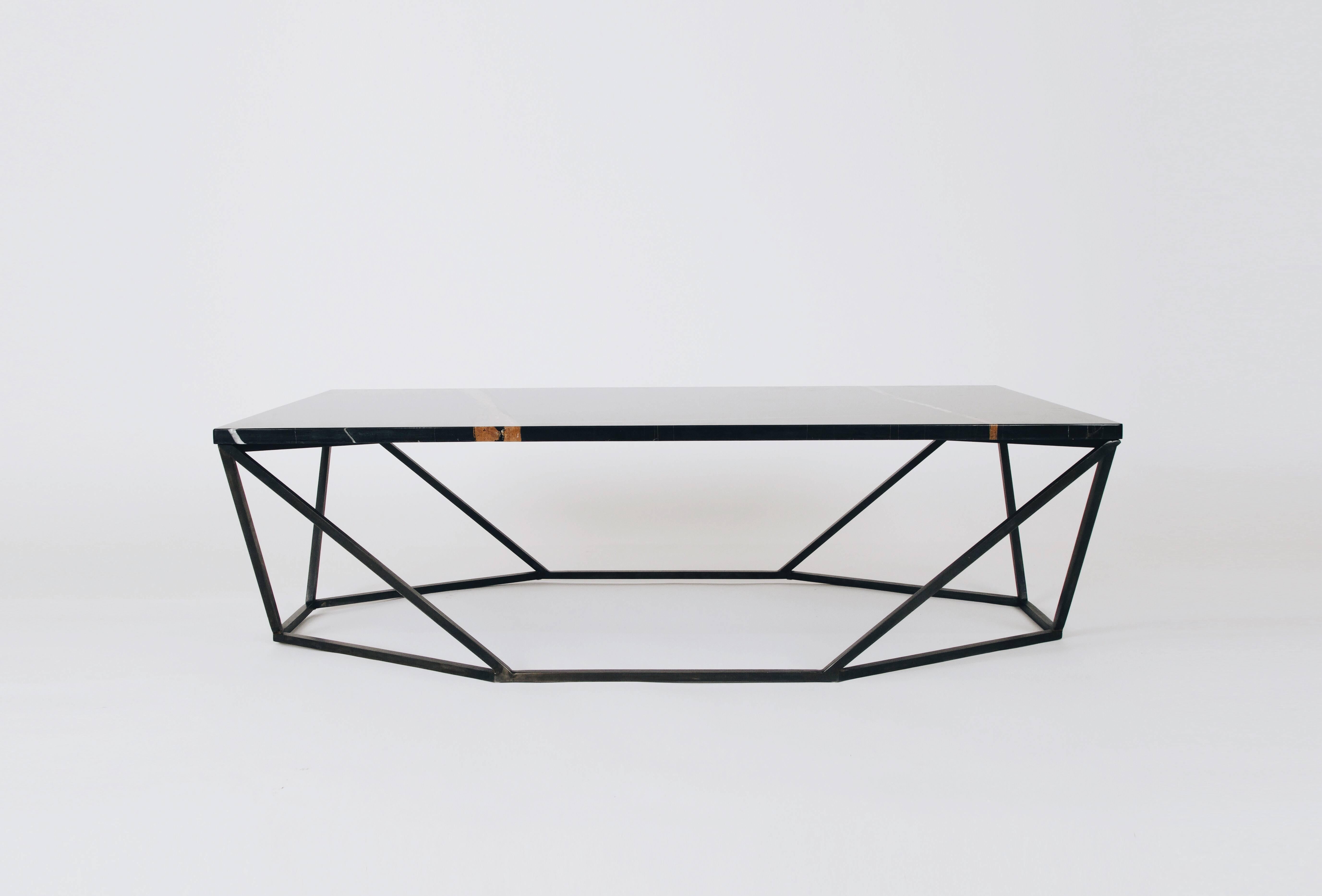 This rich finish combination for the dusk coffee table features a geometric blackened-steel base with a black nero Durata mable tabletop.

The octagon-meets-rectangle shape transforms when viewed from different angles. The dusk coffee table was