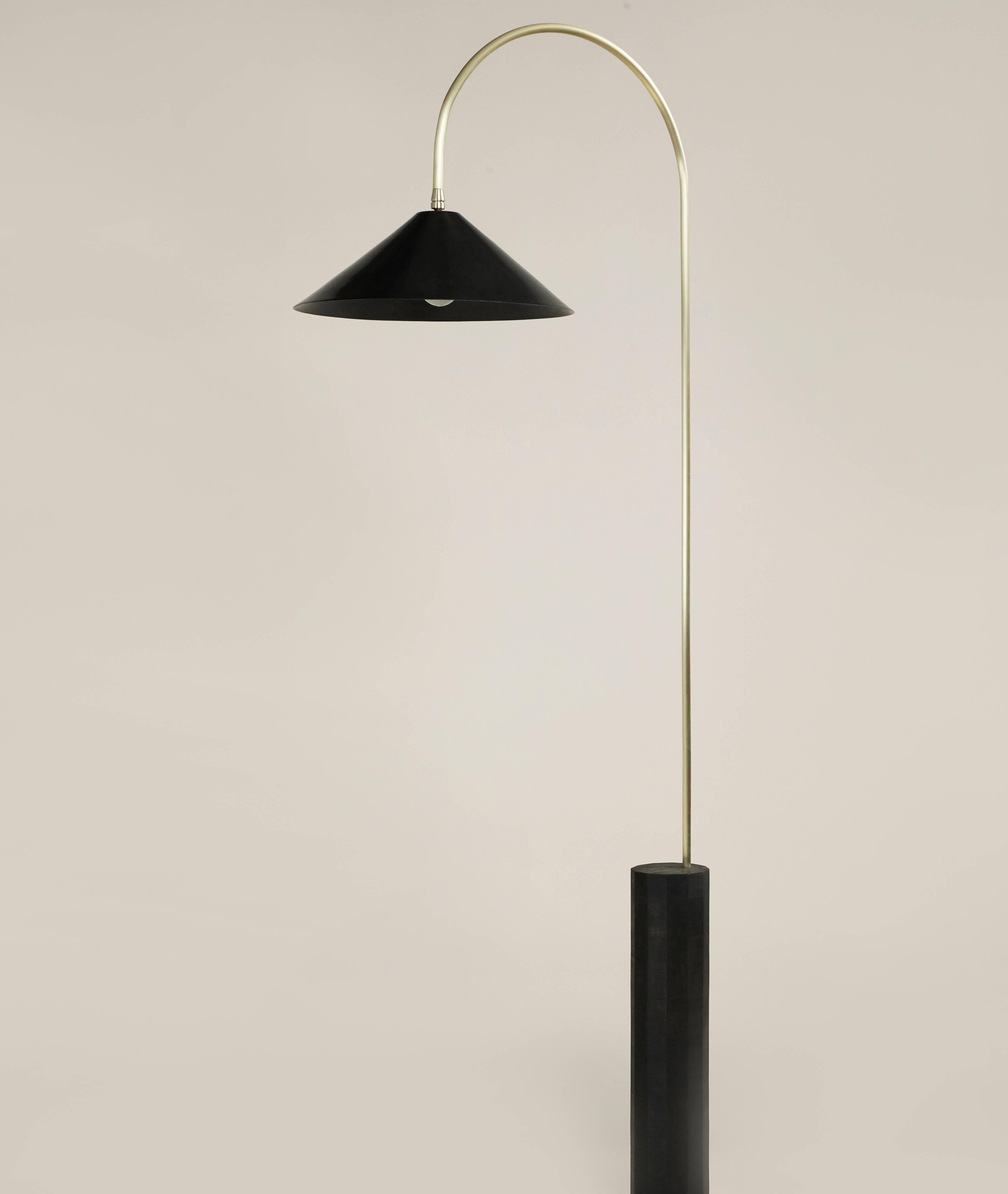 Inspired by the iconic Bishop’s hook cast-iron street lamps that illuminate New York City’s Williamsburg Bridge, this elegant tall floor lamp is comprised of a blackened-steel hand-spun shade, brushed-brass curved neck and ebony-stained ashwood