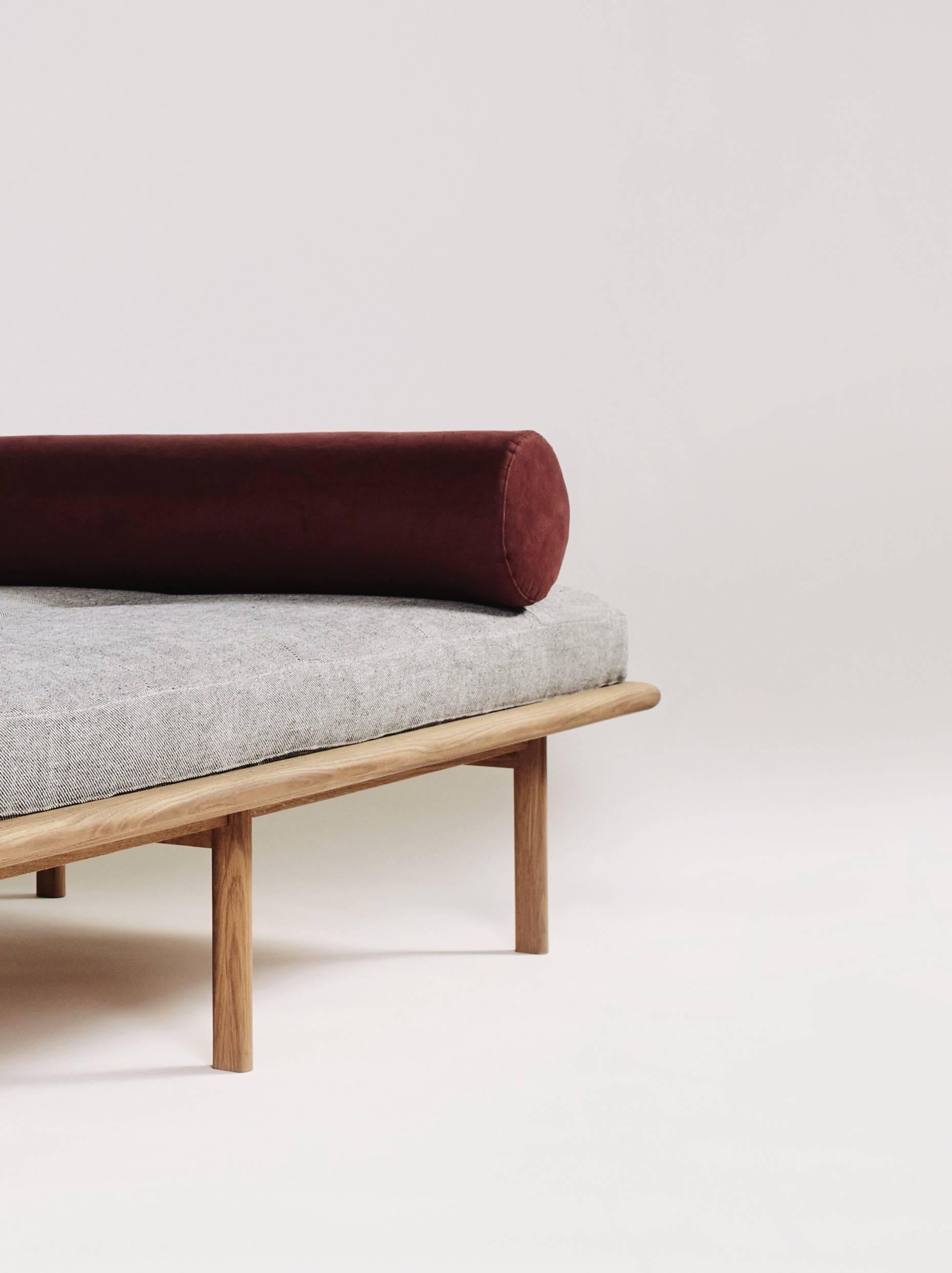 Scandinavian minimalism and luxurious texture come together in this six-legged modern daybed. The white-oak base is comprised of a rounded-edge frame and distinctively hand-shaped legs, which taper on two sides. The plush cushion features centred