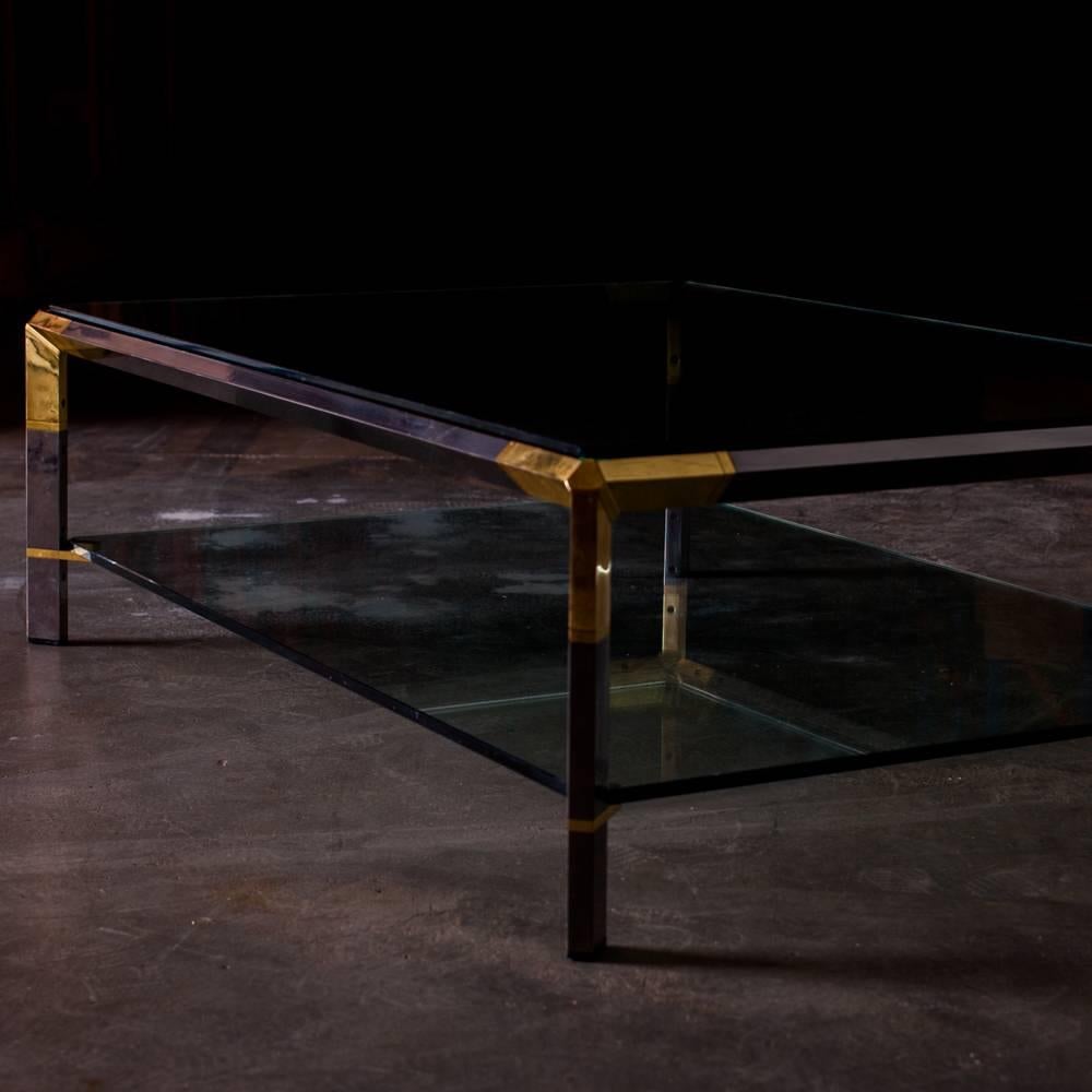 This coffee table is in brass and metal, two level in glass. This product was made in France and is signed. 

In the style of Maison Jansen and Maison Charles, this table is elegant and qualitative.