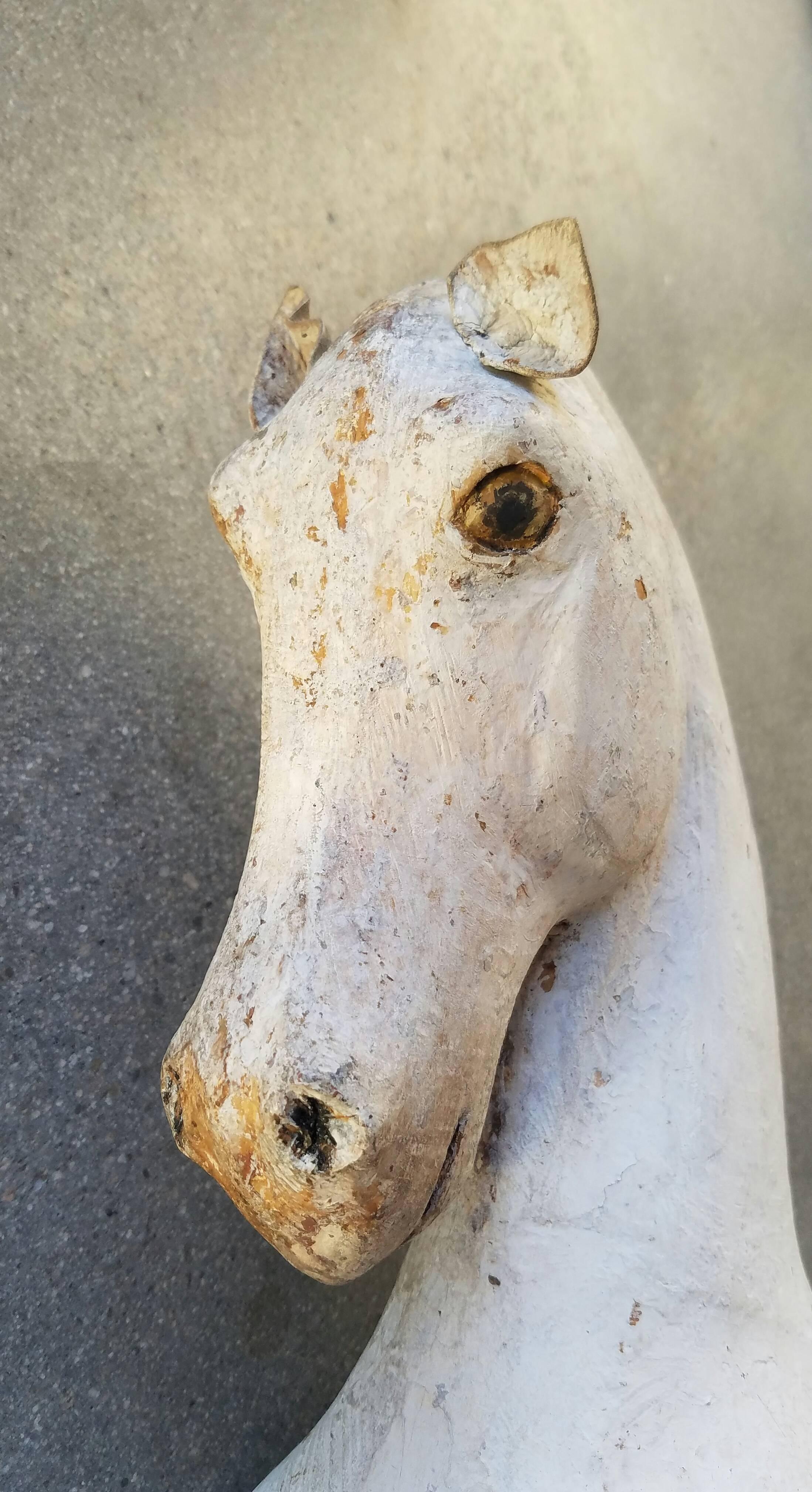 This antique wooden child's horse has horse hair tail, painted mane, eyes, hooves and coat with beautiful expression and size.