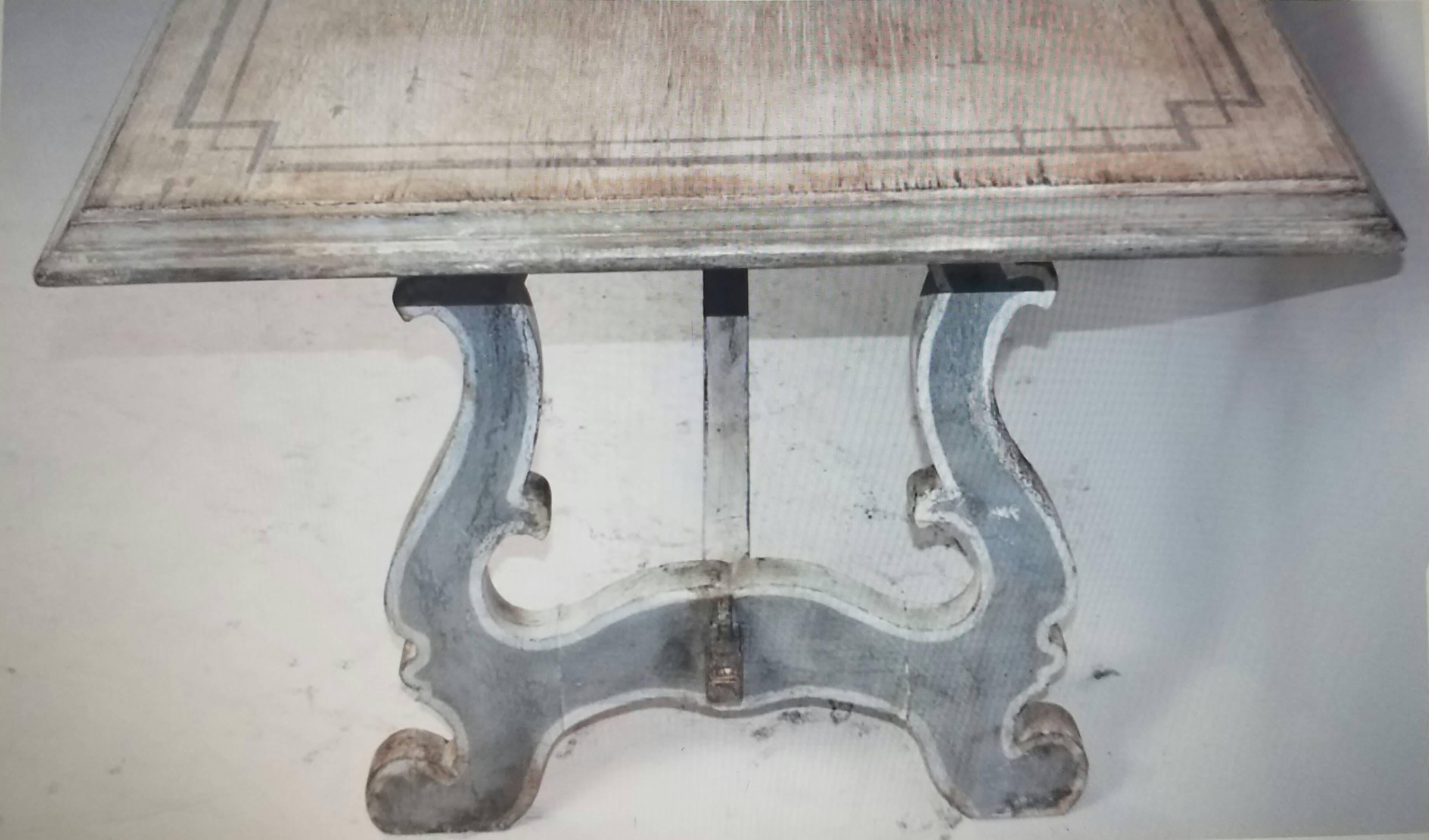 This antique Italian trestle table has beautiful grey painted striping and an amazing distressed finish on the top and legs. It's a real stunning piece.