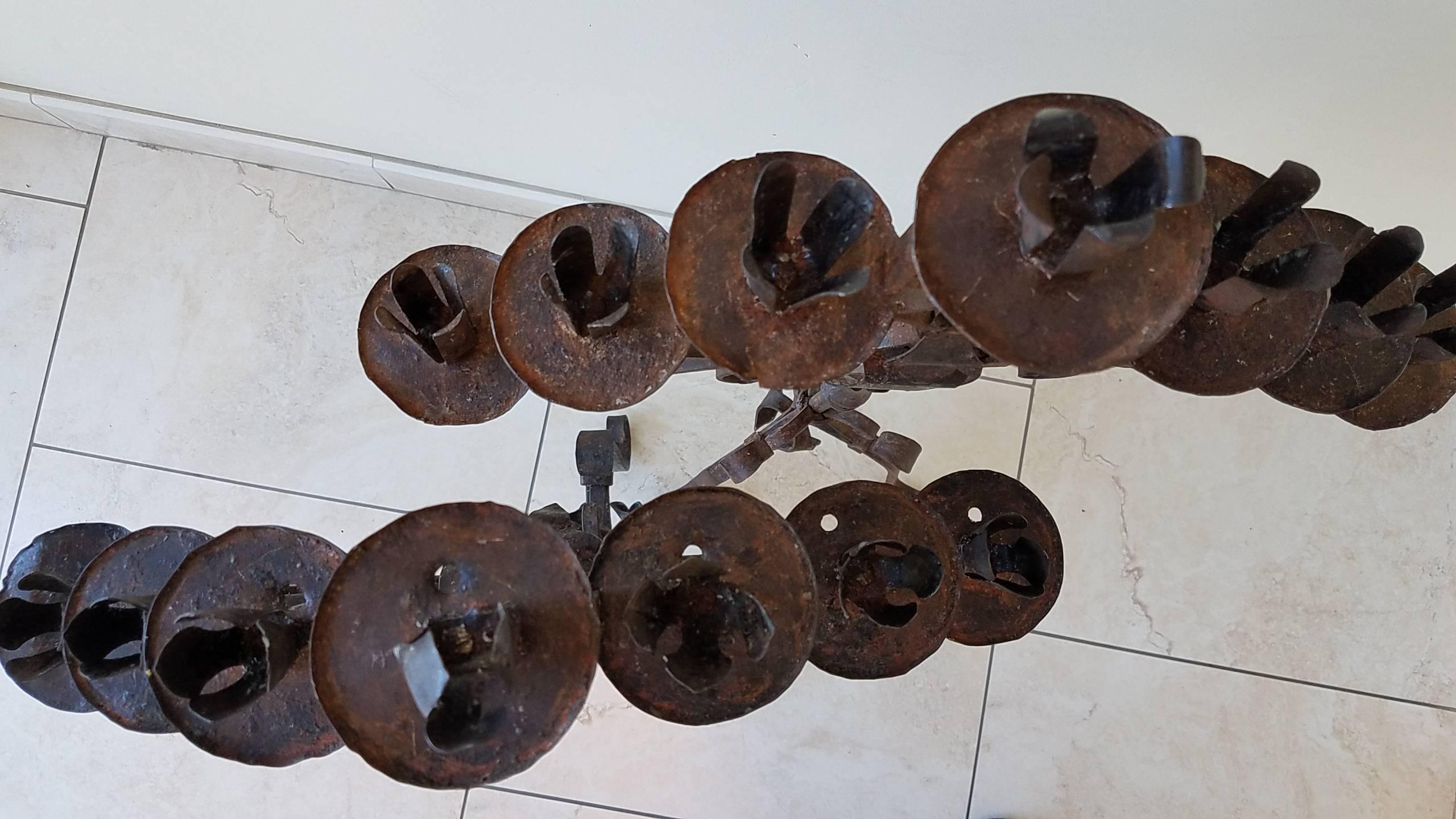 These seven candle antique candelabras are in beautiful condition with one fpetal of the floret missing on the top of one candelabra. Iron has great patina and are heavy for their size.