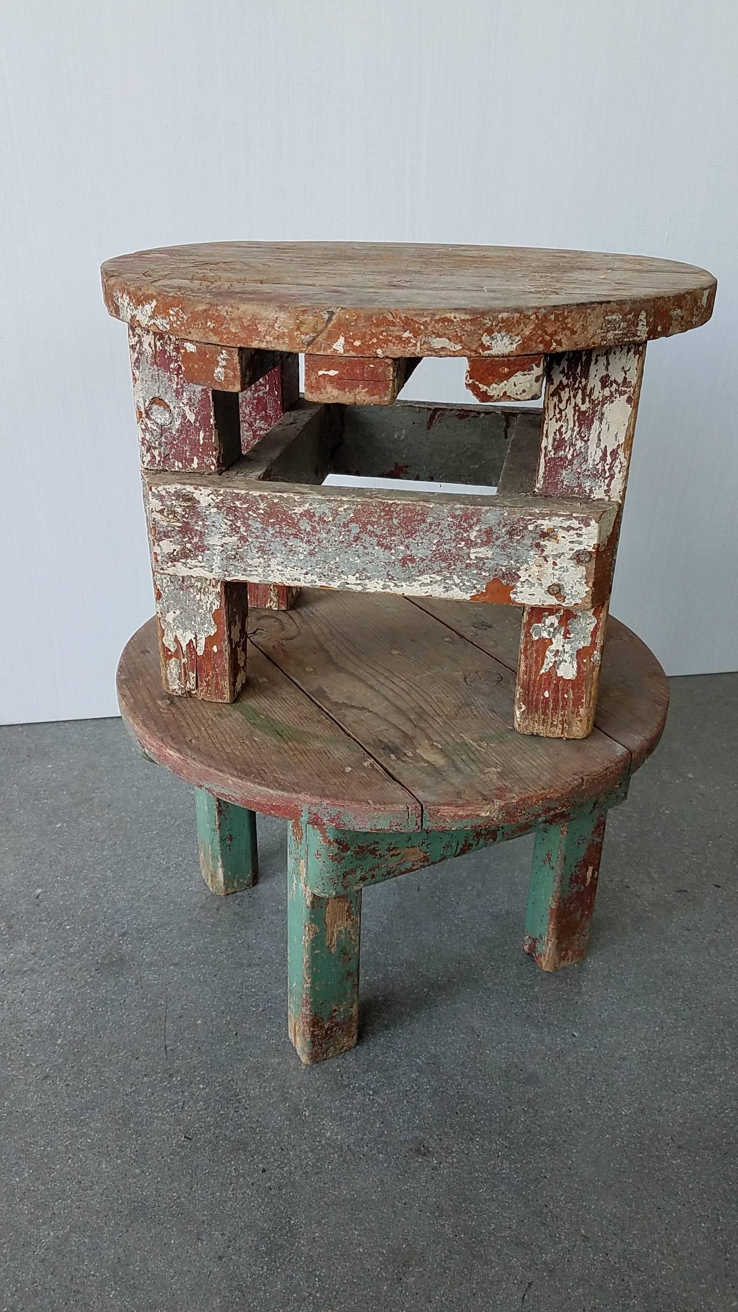 These two stools somewhat stand as a pair and yet are different in their paint. One stool has silver metallic and a beautifully weathered carnelian. Other is Robin's Egg Blue and Carnelian. Condition is very sturdy.  Makes a great small stage for a