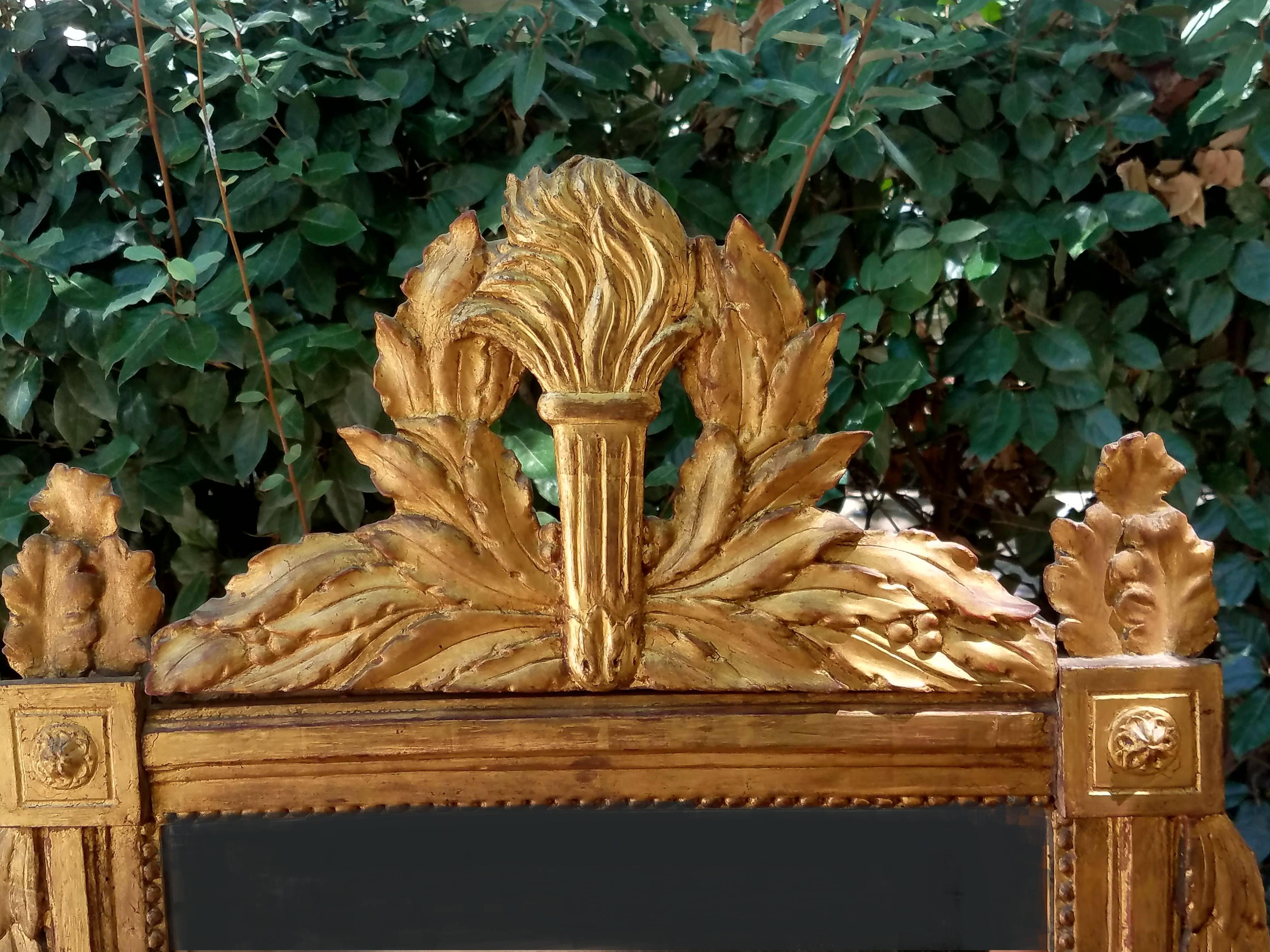 Hand-Carved Beautiful 18th Century Carved French Gilt Mirror with Flaming Torch and Laurel For Sale