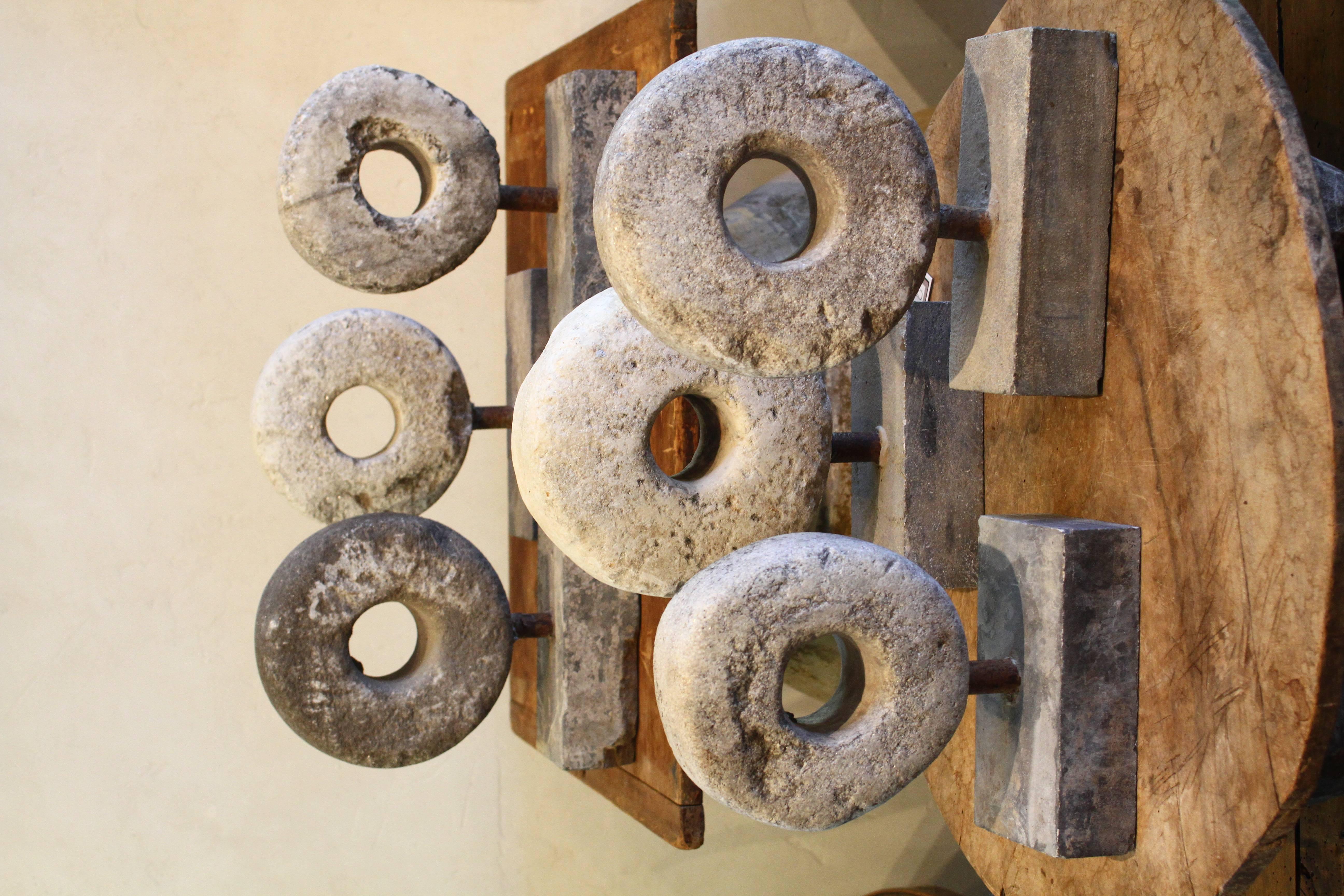 These one of a kind antique small millstones are carved stone spheres and add the perfect industrial piece to the decor puzzle.