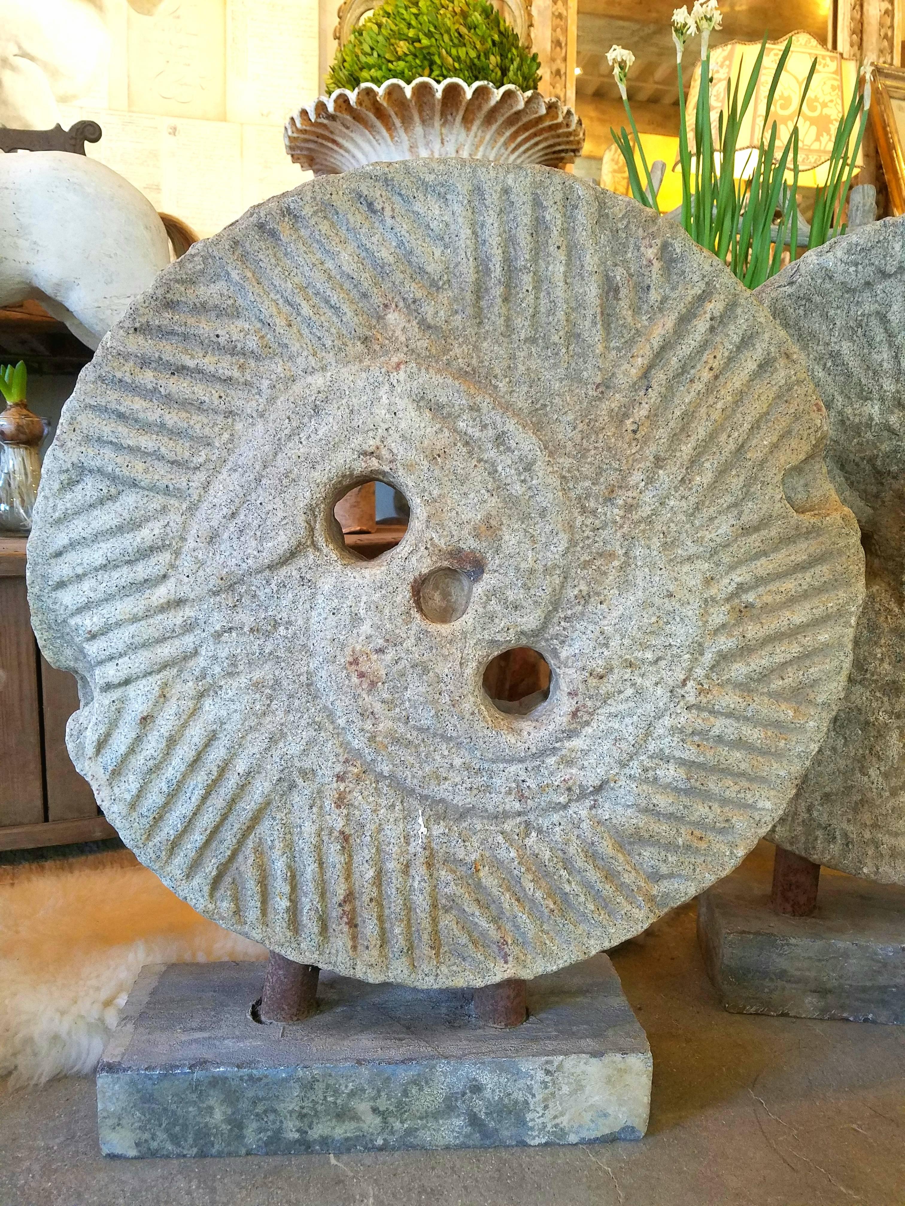 These are a showstopper!  These Antique 19th Century Millstones are a gorgeous addition to any vignette and adds an industrial aesthetic to any decor.  Mounted on cement block, these millstones are carved with great size and depth and have beautiful