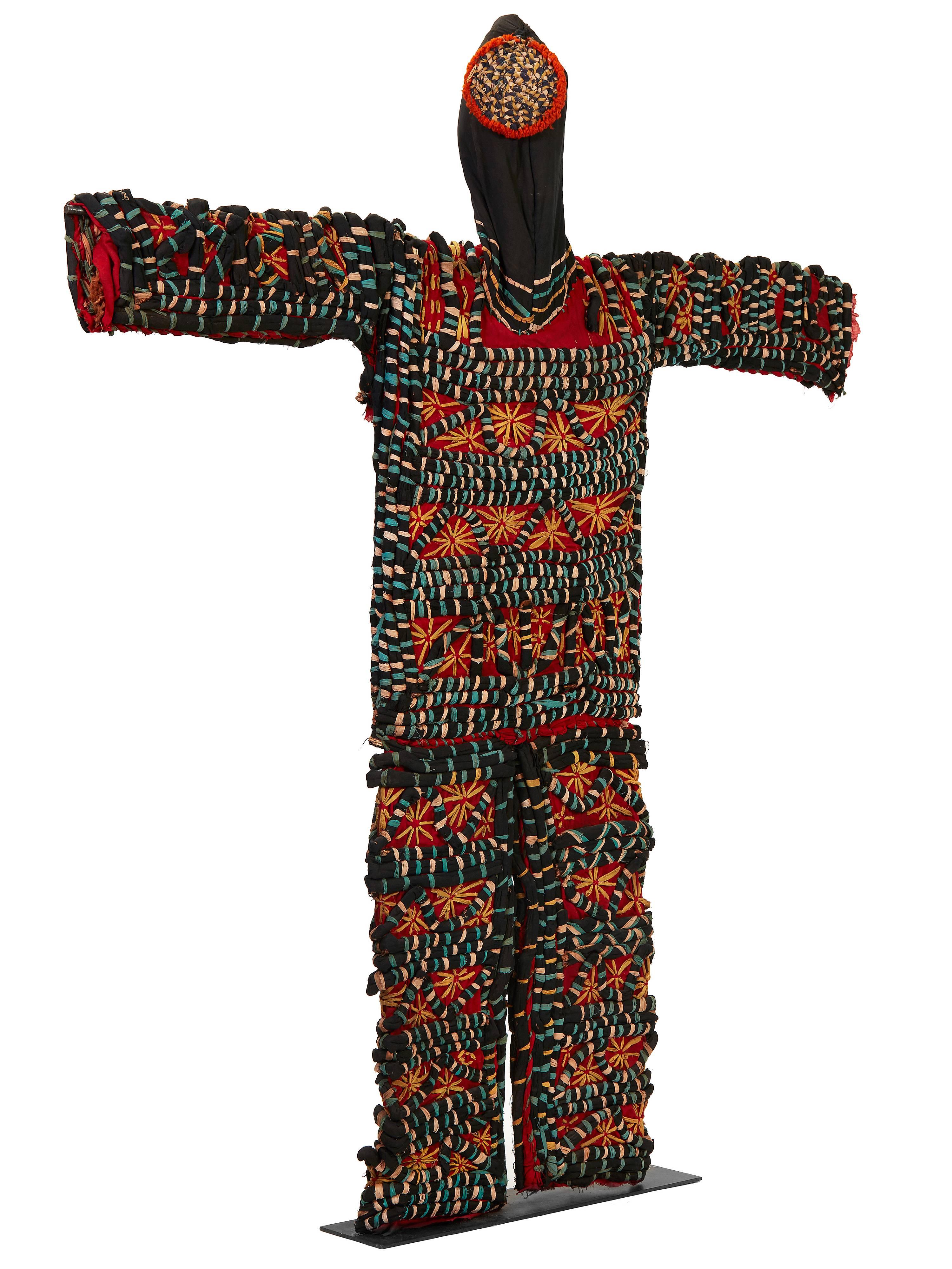 In Northern Nigeria, Igbo tribes host maiden spirit festivals, where men in colorful costumes perform women’s dances to entertain onlookers. Constructed from cloth, patchwork and applique, this starred and striped pattern is meant to mimic female
