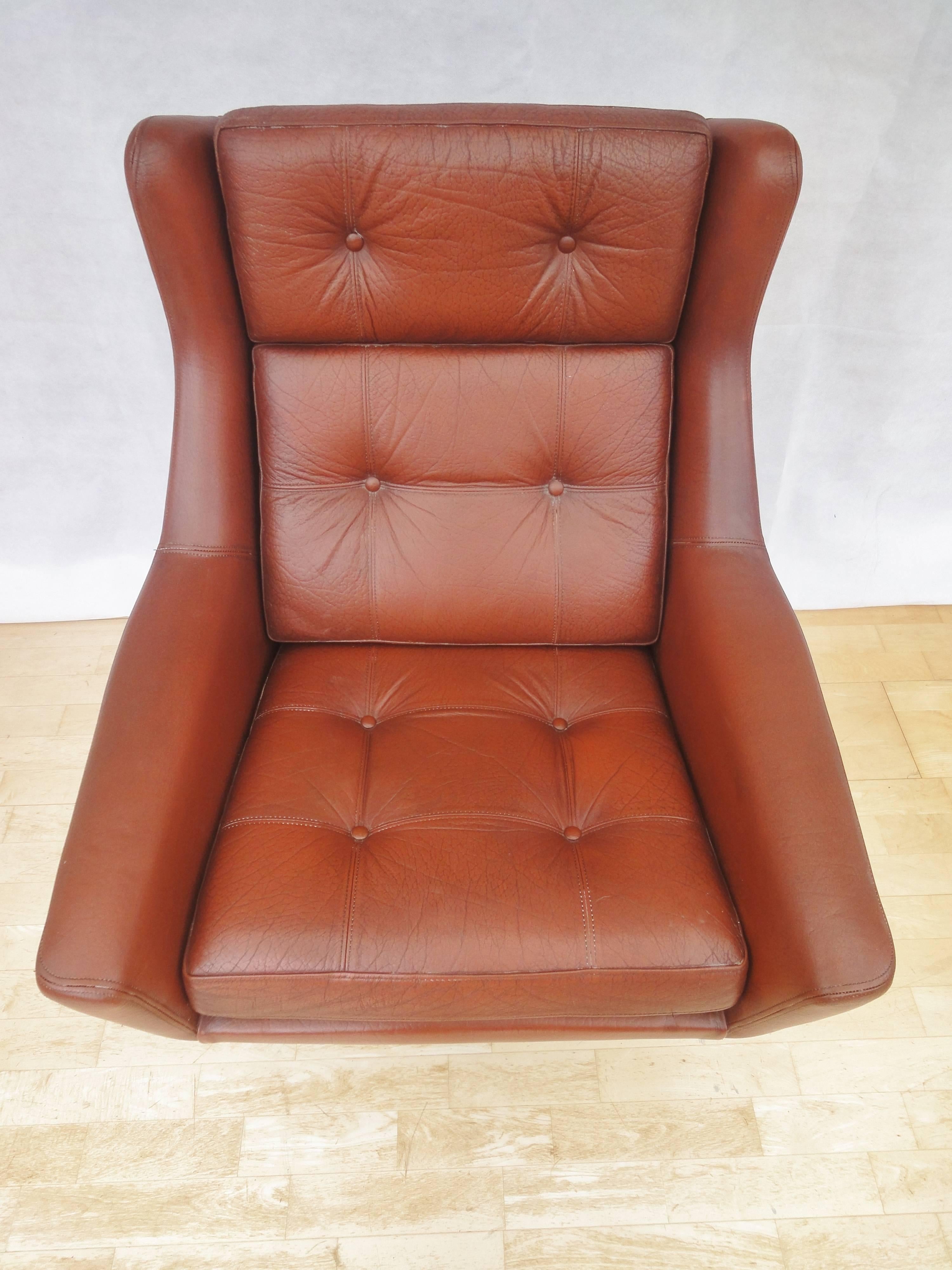 Designer: Danish Design.

Manufacturer: Unknown.

Country: Denmark.

Date: 1960s.

Material: Genuine red leather upholstery with chrome swivel base.

Maximum dimensions: Width 82cm, depth 87cm, height 94cm and seat height
