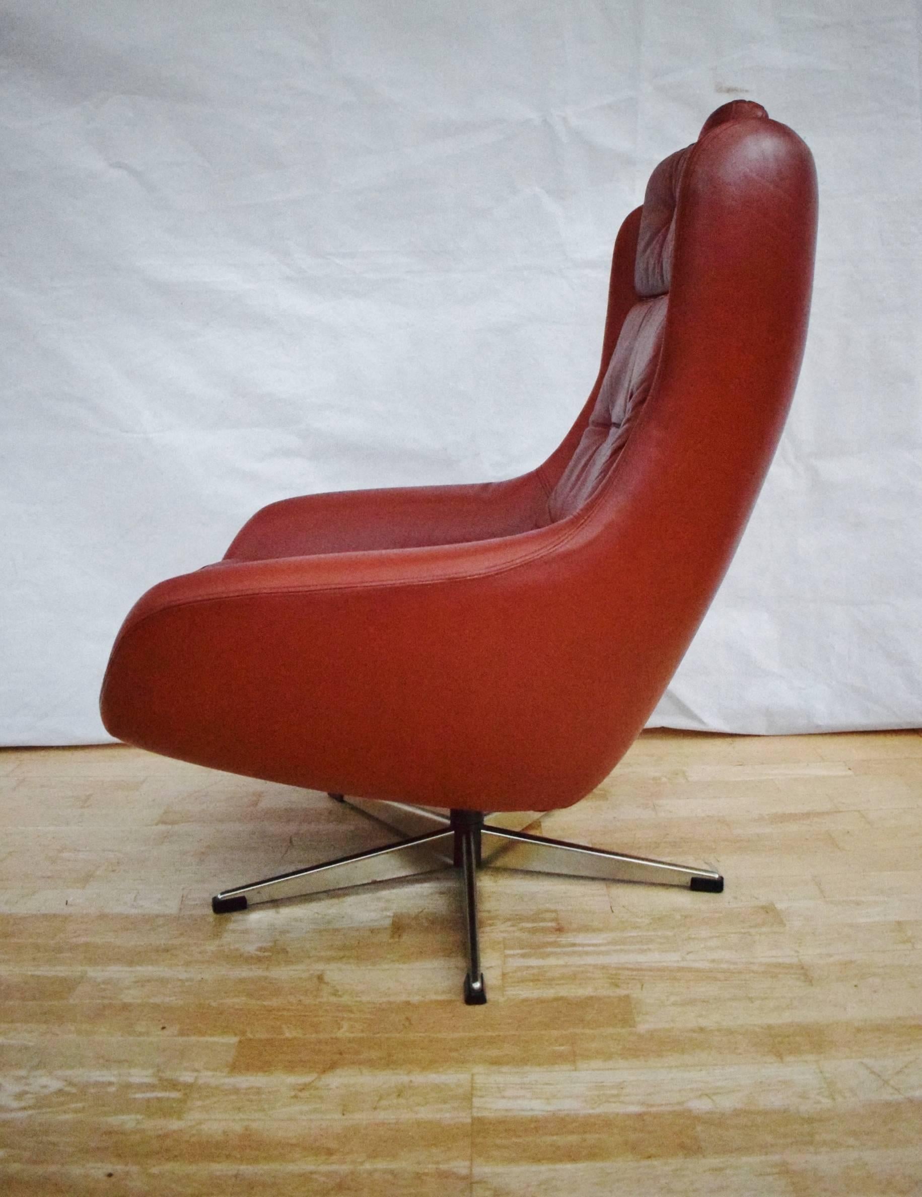 Designer: Danish Design.

Manufacturer: Unknown.

Country: Denmark.

Date: 1960s.

Material: Genuine red leather upholstery with metal swivel base.

Maximum Dimensions: Width 78cm, depth 80cm, height 96cm and seat height