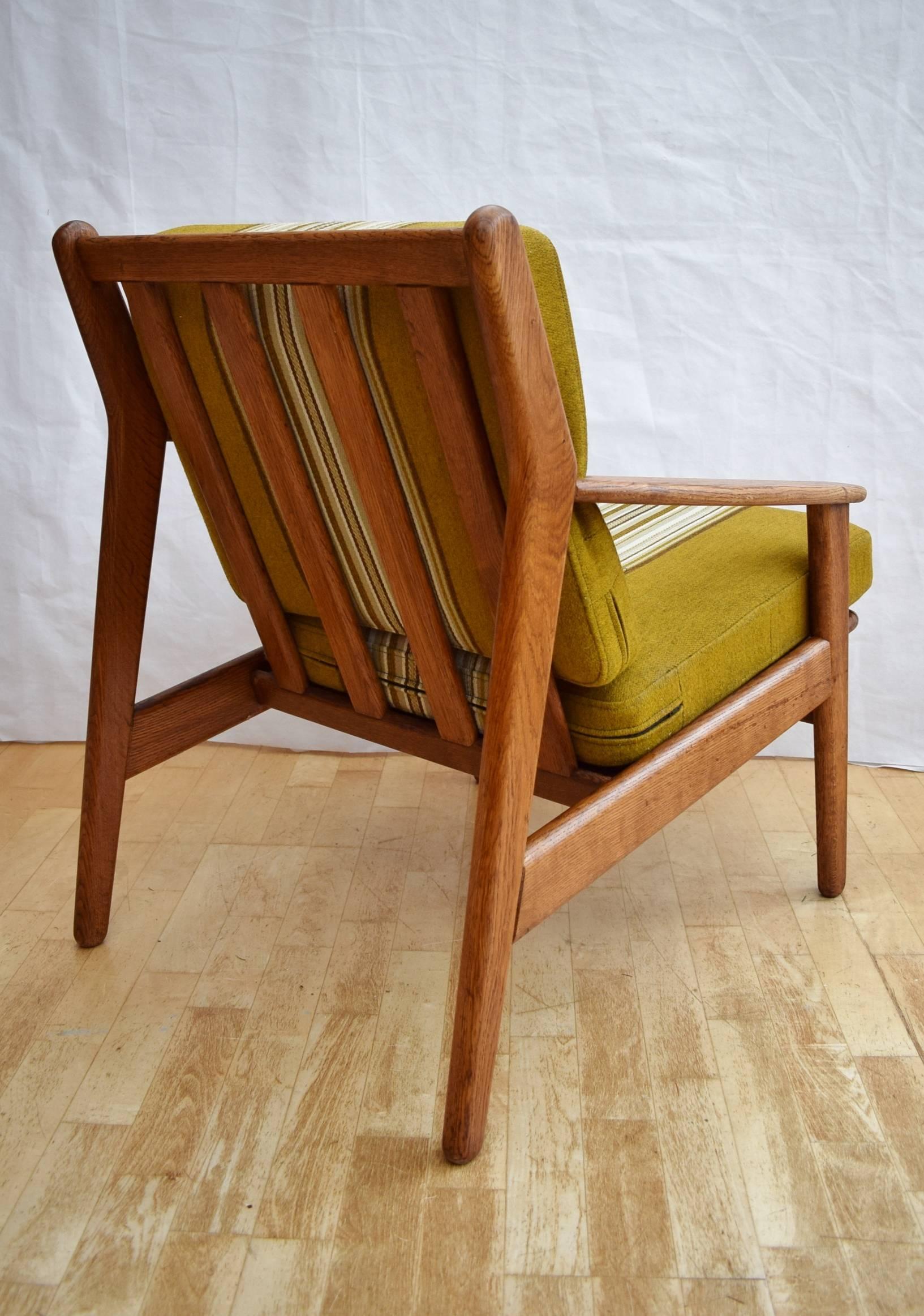 Designer: Poul M. Volther

Manufacturer: FDB Møbler

Country: Denmark

Date: 1955

Material: Solid oak frame with sprung Woolen cushions

Maximum Dimensions: Width 67 cm, depth 82 cm, height 80 cm and seat height 46 cm

Condition: