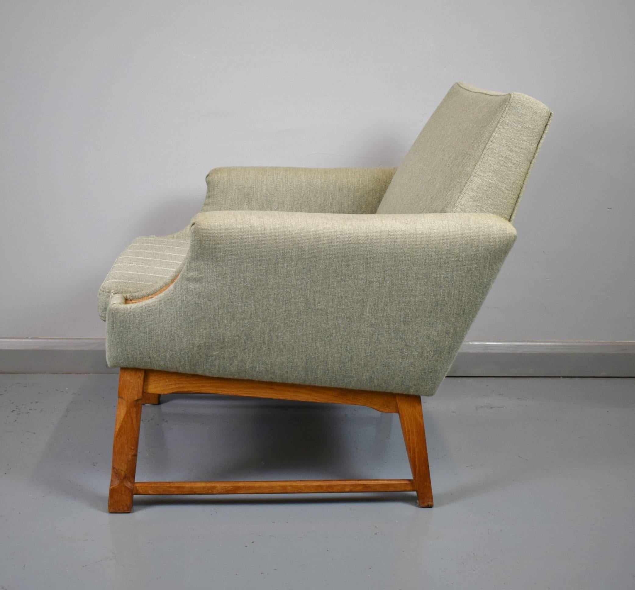 Designer: Danish design

Manufacturer: Unknown

Country: Denmark

Date: 1950s

Material: Wool upholstery and oak detailing.

Maximum dimensions: seat 74 cm W, 76 cm deep, and 76cm tall.
Footstool 45 cm wide, 35 cm deep, and 40 cm
