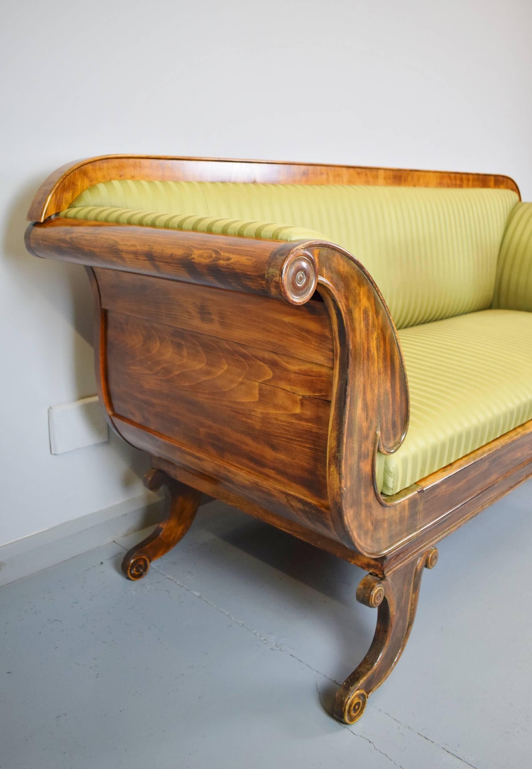 A stunning Victorian era scroll end sofa

We date this piece to be around the mid-19th century, circa 1850

The piece is constructed from mahogany and beechwood with beautiful patinated figuring to the wood

The upholstery is a green striped