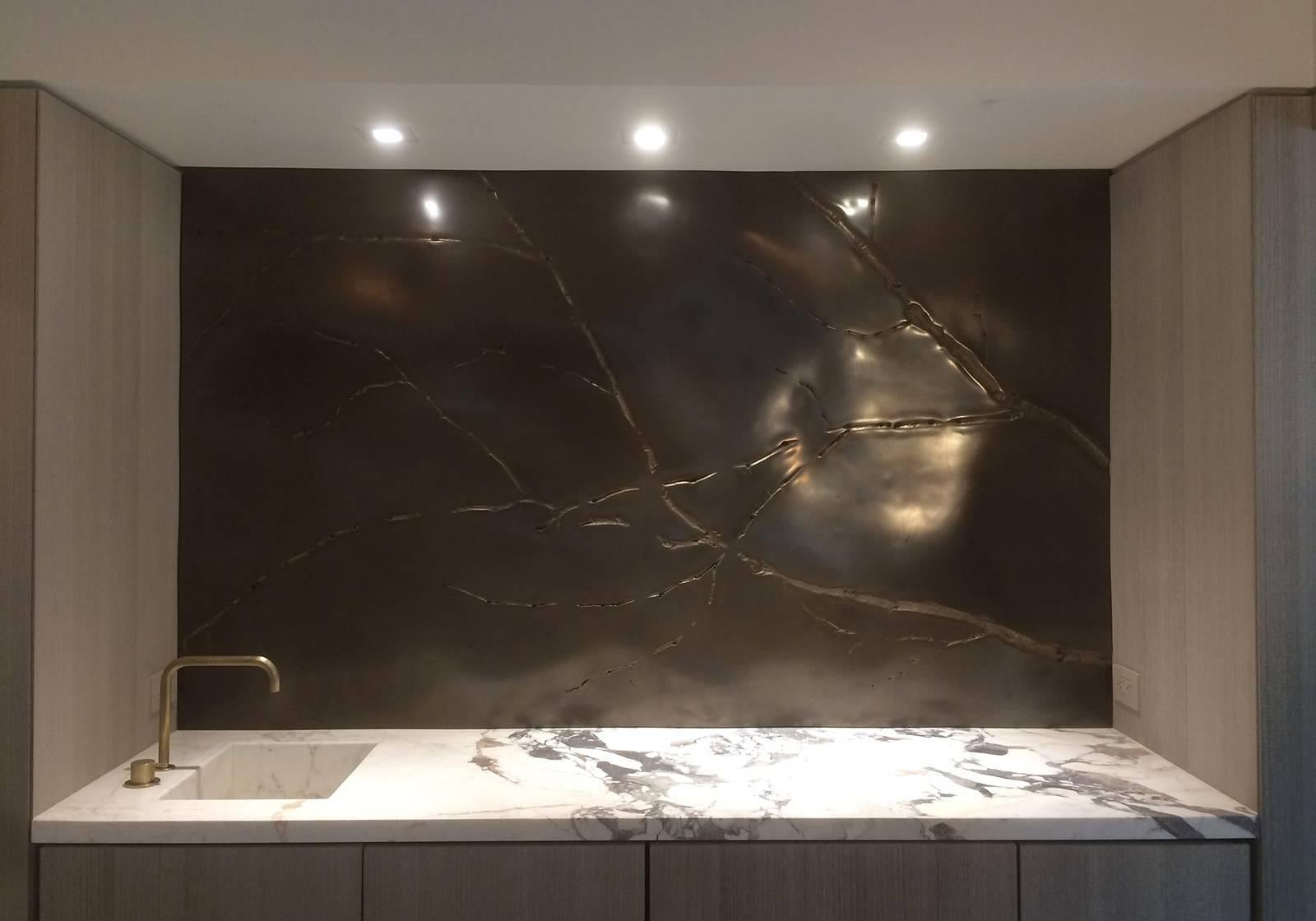 Of unparalleled stature and rarefied beauty is this bronze surface art which features the high texture of branches in relief against austere atmospherics of a polished undulating field. The countering natures in this Minimalist vocabulary create