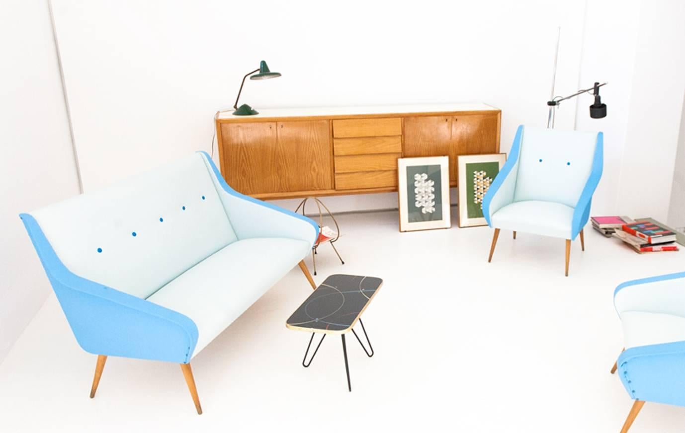 This sofa was designed and produced in Sweden during the 1950s and features a blue skai leather upholstery.