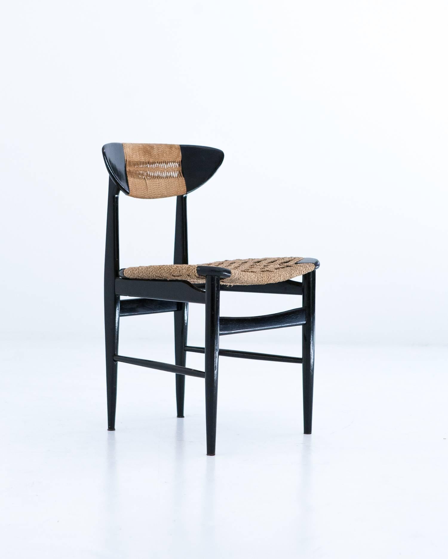 This set of six chairs was designed and produced in Denmark in the 1950s. Made of black lacquered wood and wicker.