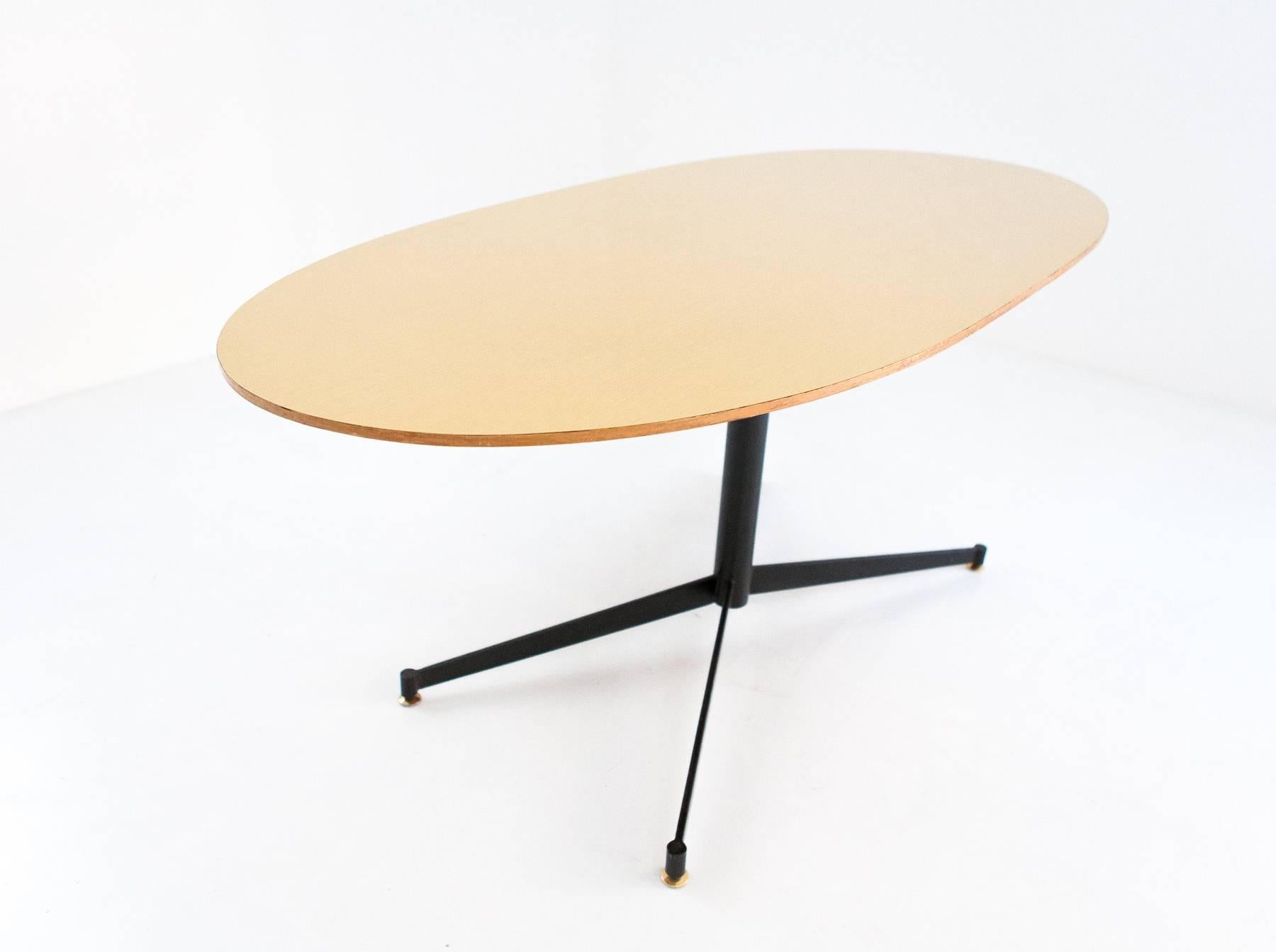 Italian Mid-Century Modern table, 1950s
Iron frame, brass feets and wooden top laminated in formica.
 