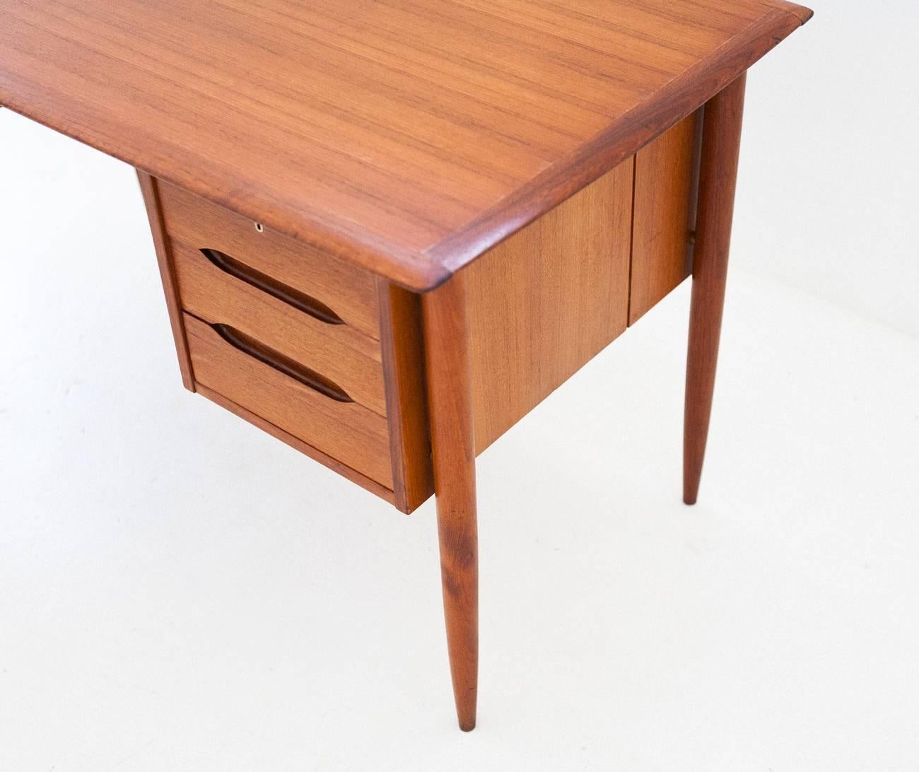 This table with chest of drawers was manufactured in Denmark since 1950's 
It's restored and in very good conditions.
This desk can also be used as a centerpiece because it has a bookcase on the opposite side of the seat

Global shipping is