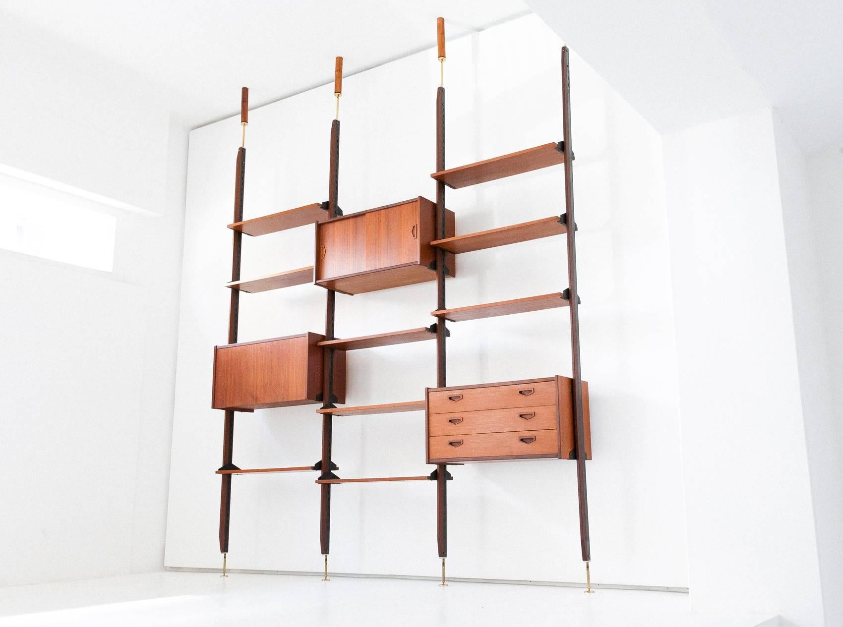 Bookshelf/wall unit
Italian design
1950s
Teak, iron, brass

Completely restored

The height is adjustable, just specify your ceiling height for a confirmation

The wooden support to the ceiling is just for the pictures

Worldwide shipment
