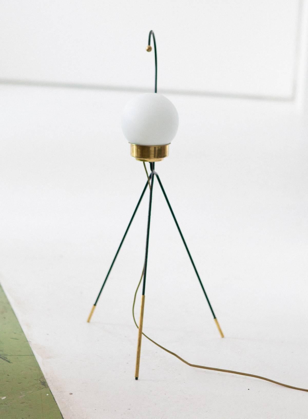 An Italian modern floor or table lamp from the 1950s
Iron frame with brass parts and opaline glass shade.
   