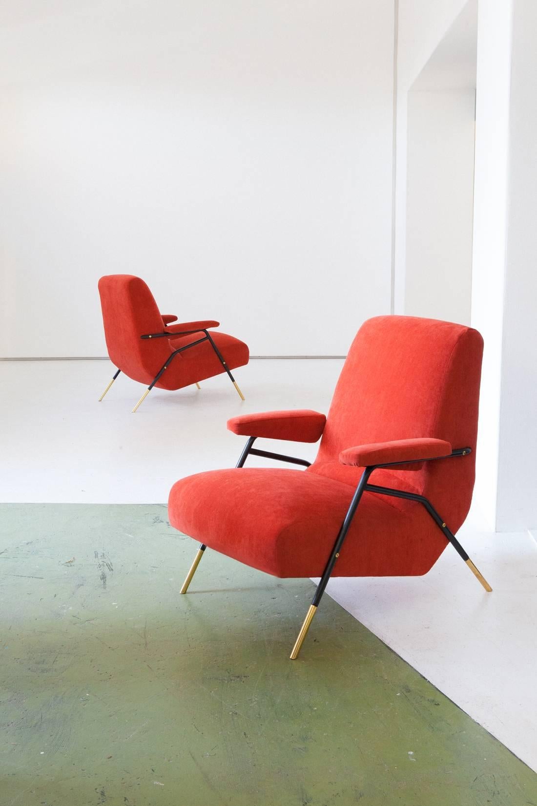 Pair of lounge chairs , Italy , 1950's
These easy chairs with armrests has a balck enameled Iron and polished brass frame , new orange velvet upholstery (the orange is more closed to the red than the yellow , also the padding is replaced ) . 
This