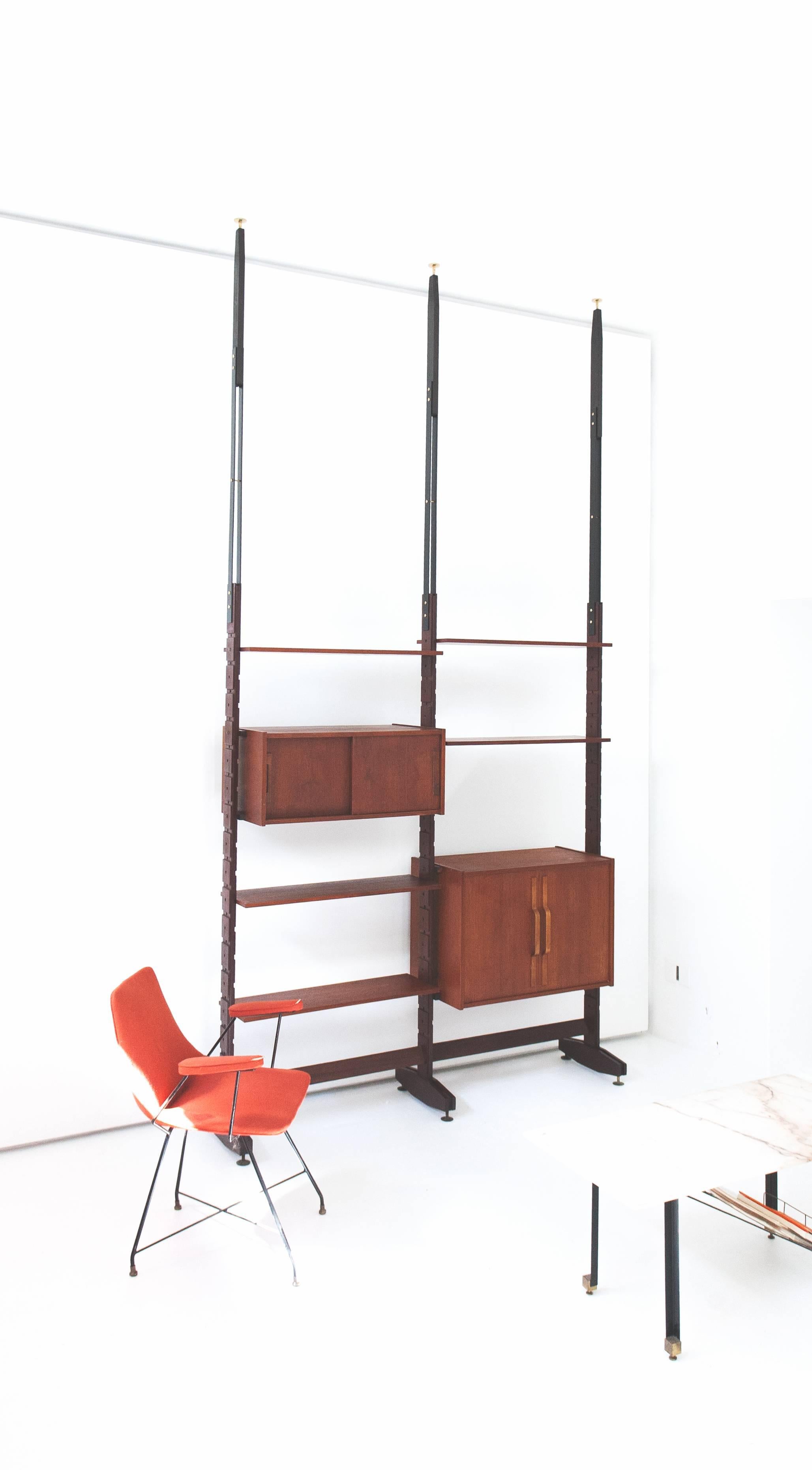 A modern bookshelf , manufactured in Italy in 1950's
The mounting of this shelving system is with  pressure between floor to ceiling but can also be mounted stand alone without the iron extensions.
The height has a long range of adjustability , just