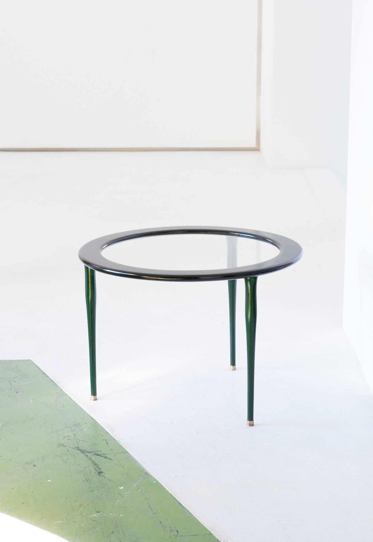 An italian modern coffee table from the 1950s
Black hand-polished wood with glass top
Bottle green hand-polished legs with brass details,
Completely restored
The original glass has some light lines accumulated over time