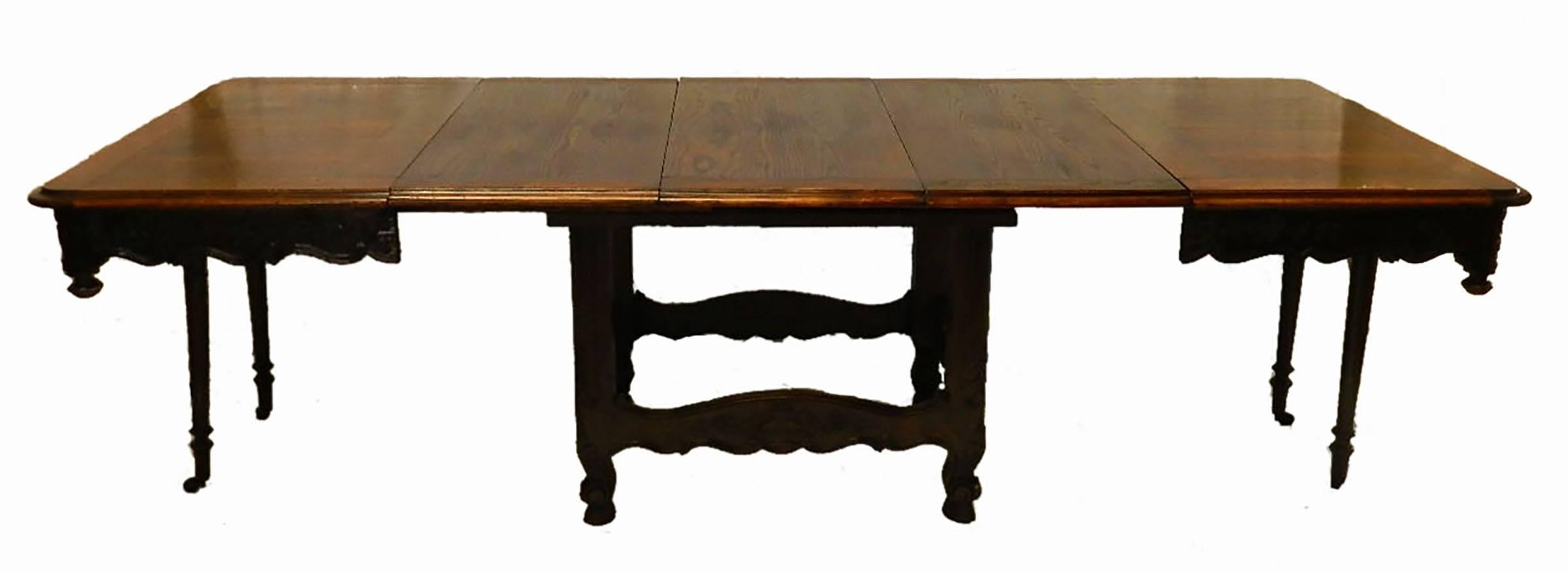Rare French, 19th century, Provençal three-leaf extending dining table.
Walnut profusely carved to base.
Hard to find mid-19th century, Louis XV revival.
The 3 later extra leaves unusually for a French extending dining table are solid, polished and