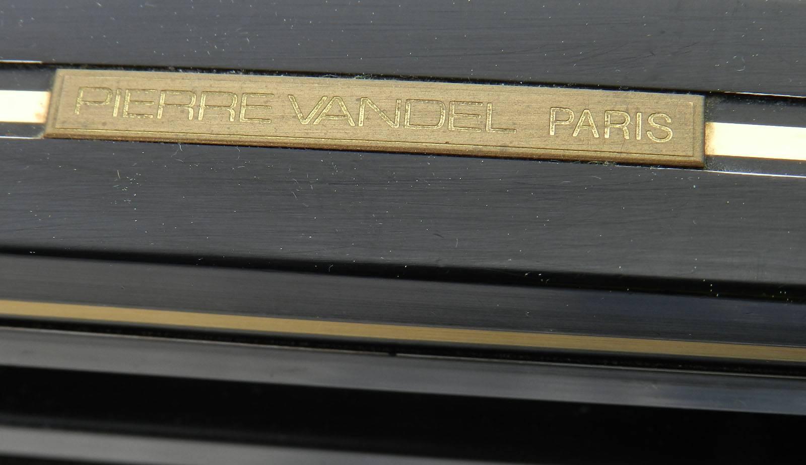 Mid-Century coffee table by Pierre Vandel, Paris, France
Makers label
Black lacquered metal frame with brass trim
Original beveled glass top
Overall good vintage condition minor scattered surface wear to frame, just one corner has slightly more as