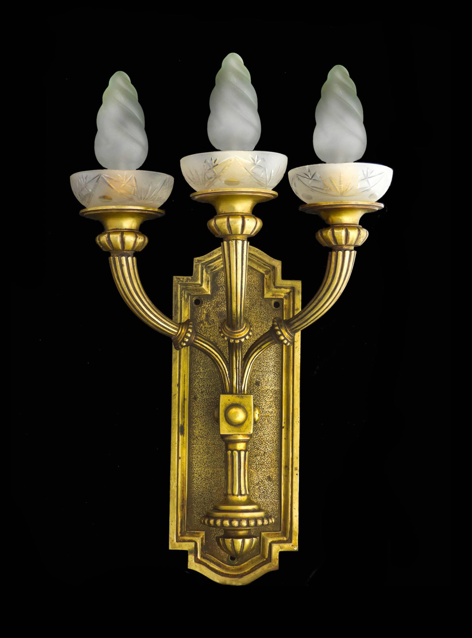 Pair of bronze Art Deco sconces 
Three arm wall lights with etched frosted glass candle cups, circa 1930
Good condition with minor signs of wear for their age.
These will be re-wired and tested to USA or UK and European standards ready to