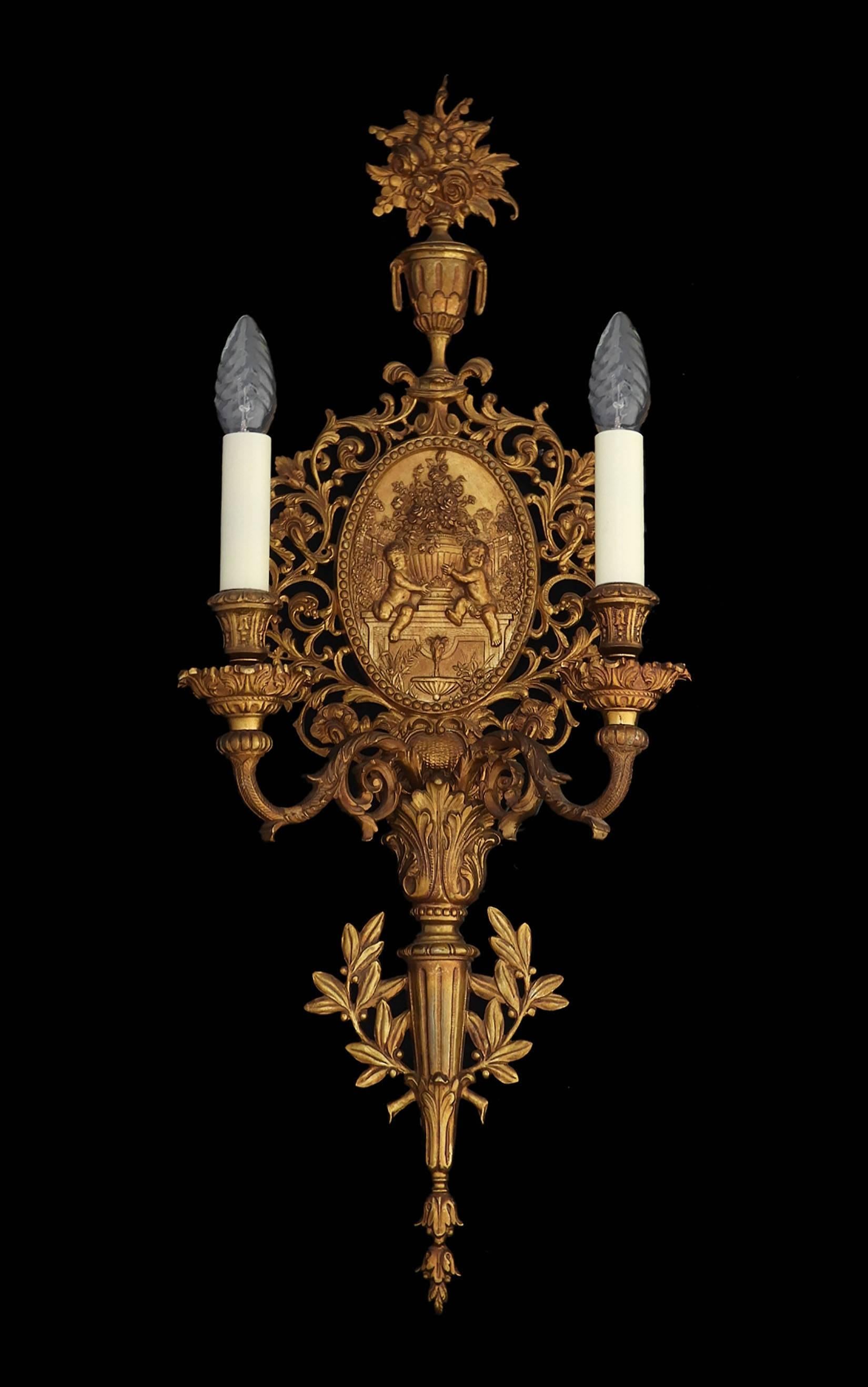 Superb French gilt bronze wall light cherub relief two branch sconce
Good condition and lovely patina
This will be re-wired and tested to USA or UK and European standards ready to install, or for your country please ask.