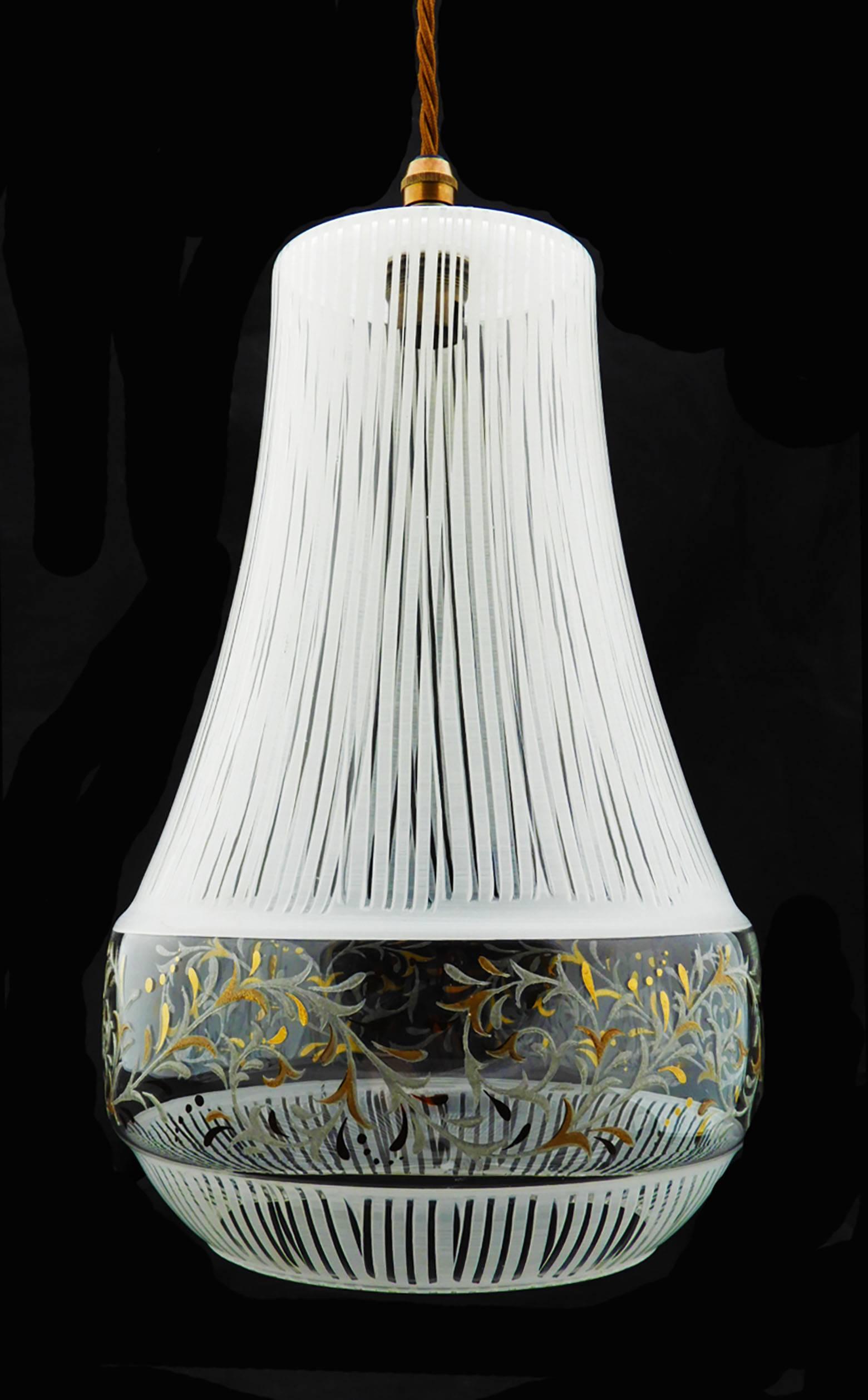 Unusual midcentury glass hand decorated pendant light, France, 1960s
A Classic form with a simple white striped decoration and delicate leaf pattern in silver and gold.
In good vintage original condition with no losses to glass.
This will be