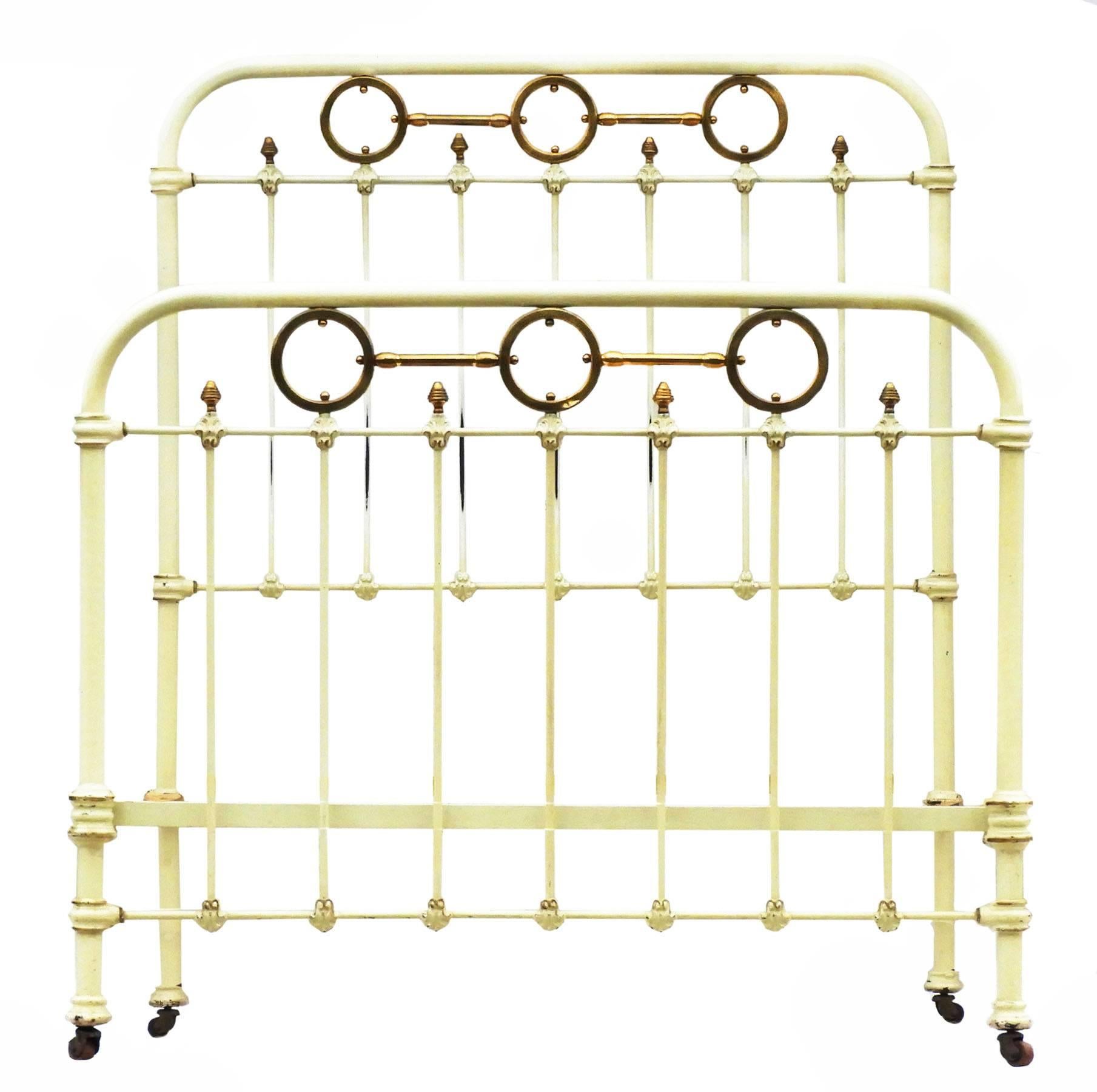French Iron and Brass single Antique Bed circa 1890 
With Brass Ring Details 
On original castors
This bed will take a 3 foot 6 inch or 45 inch wide mattress on either a slatted wood base or a spring base (not included) please ask for more info
