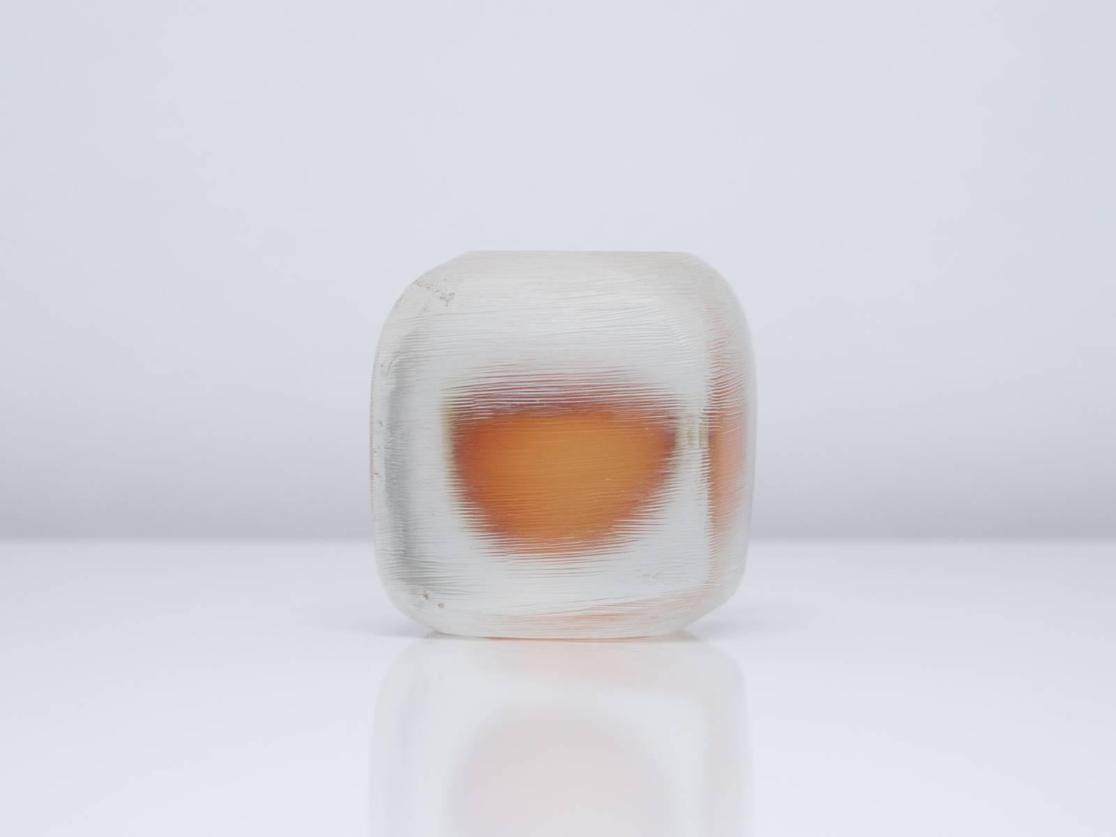 A small, polished cuboid Murano glass paperweight produced by Venini in the vetro Sommerso incisco or 