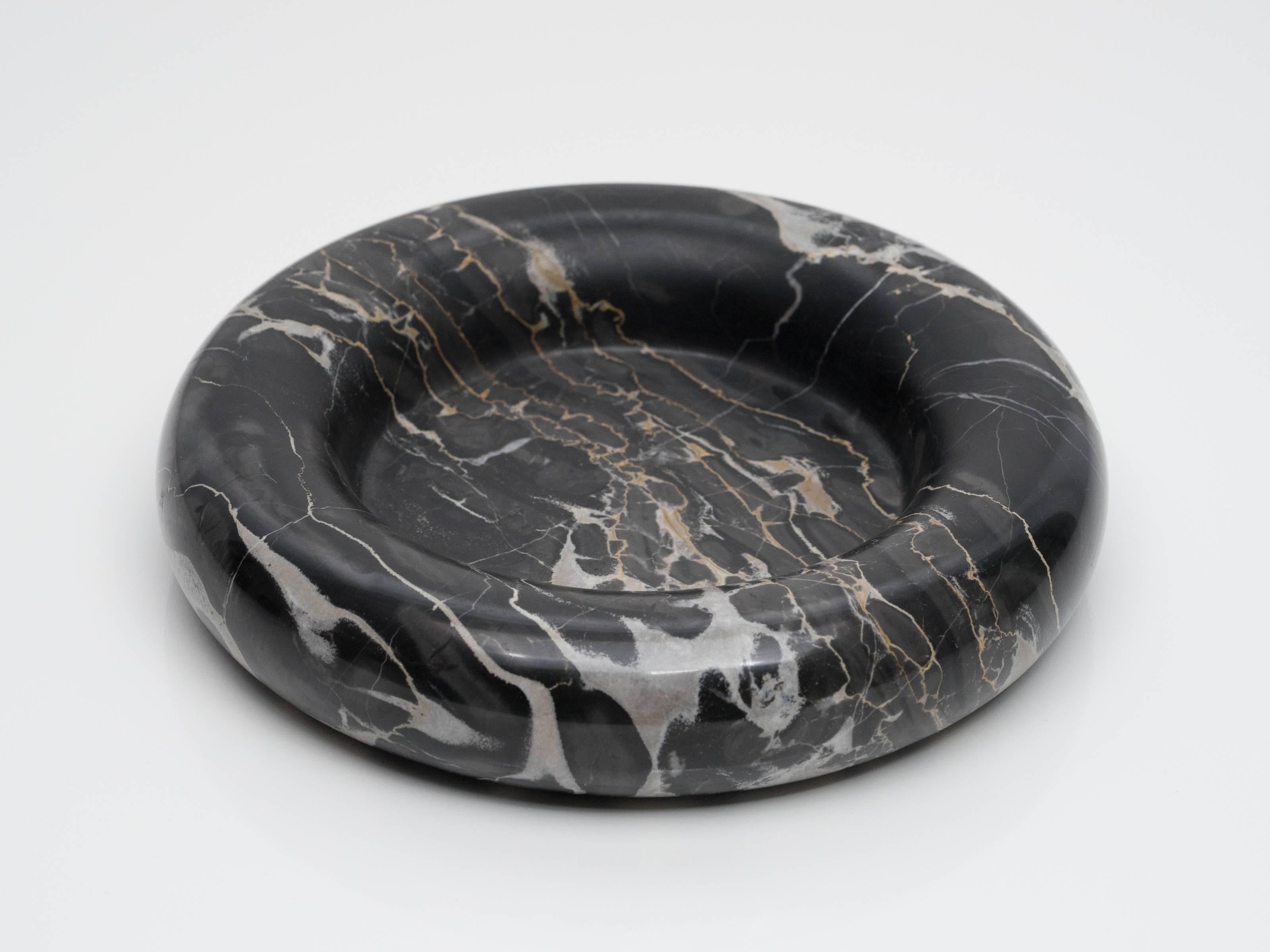 Designed as part of Up & Up’s initial collection of marble objects by some of the most respected designers of the 1970s. Made from black marble with light grey and gold veining. Flat centre surrounded by thick rounded edges, red felt on underside.