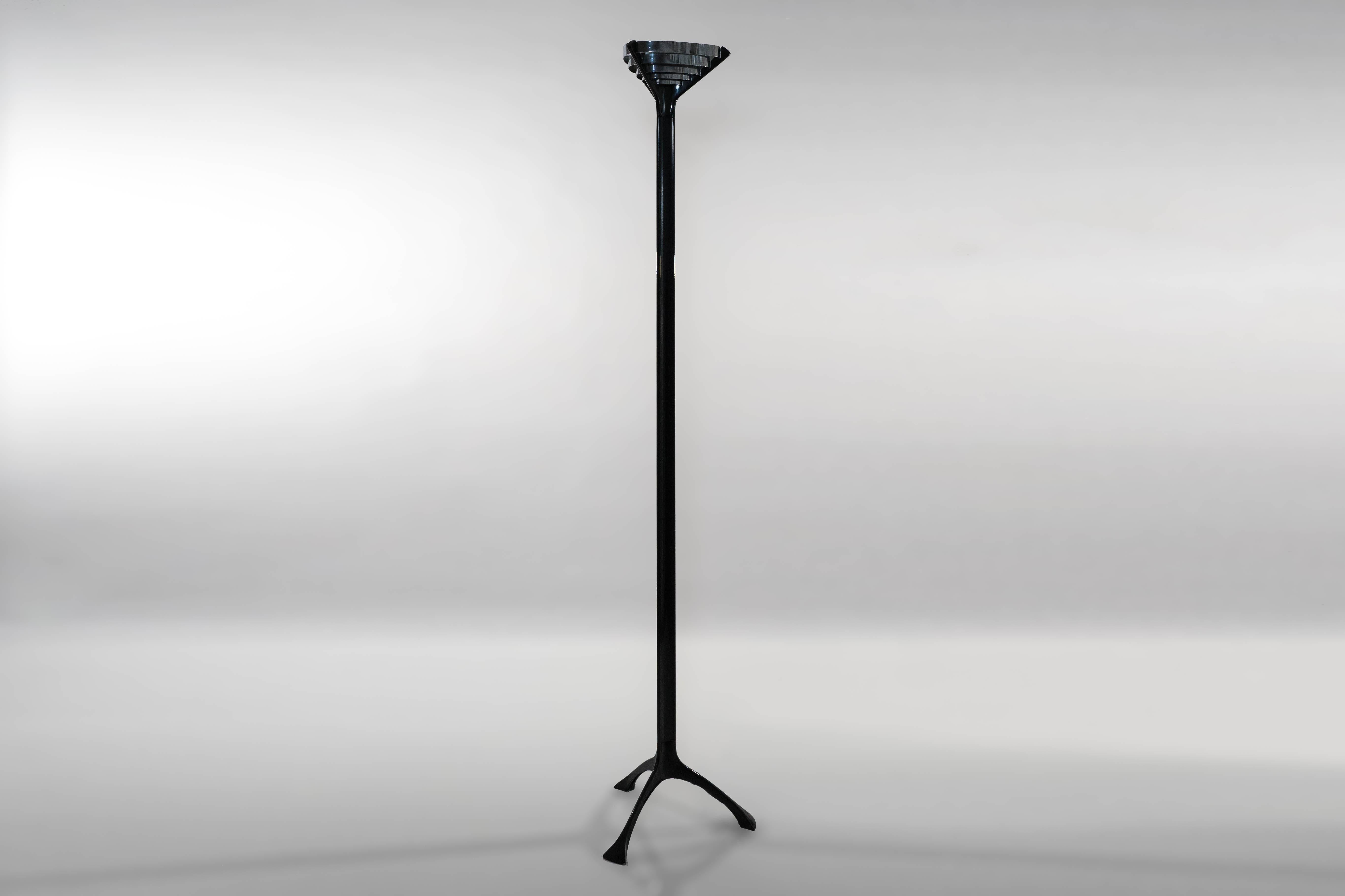 An effortlessly sleek floor lamp designed by Mangiarotti for Skipper Pollux in 1988. Three separate black lacquered aluminum elements (the tripod base, central stem and crown) are welded together to create a beautiful floor lamp with a small