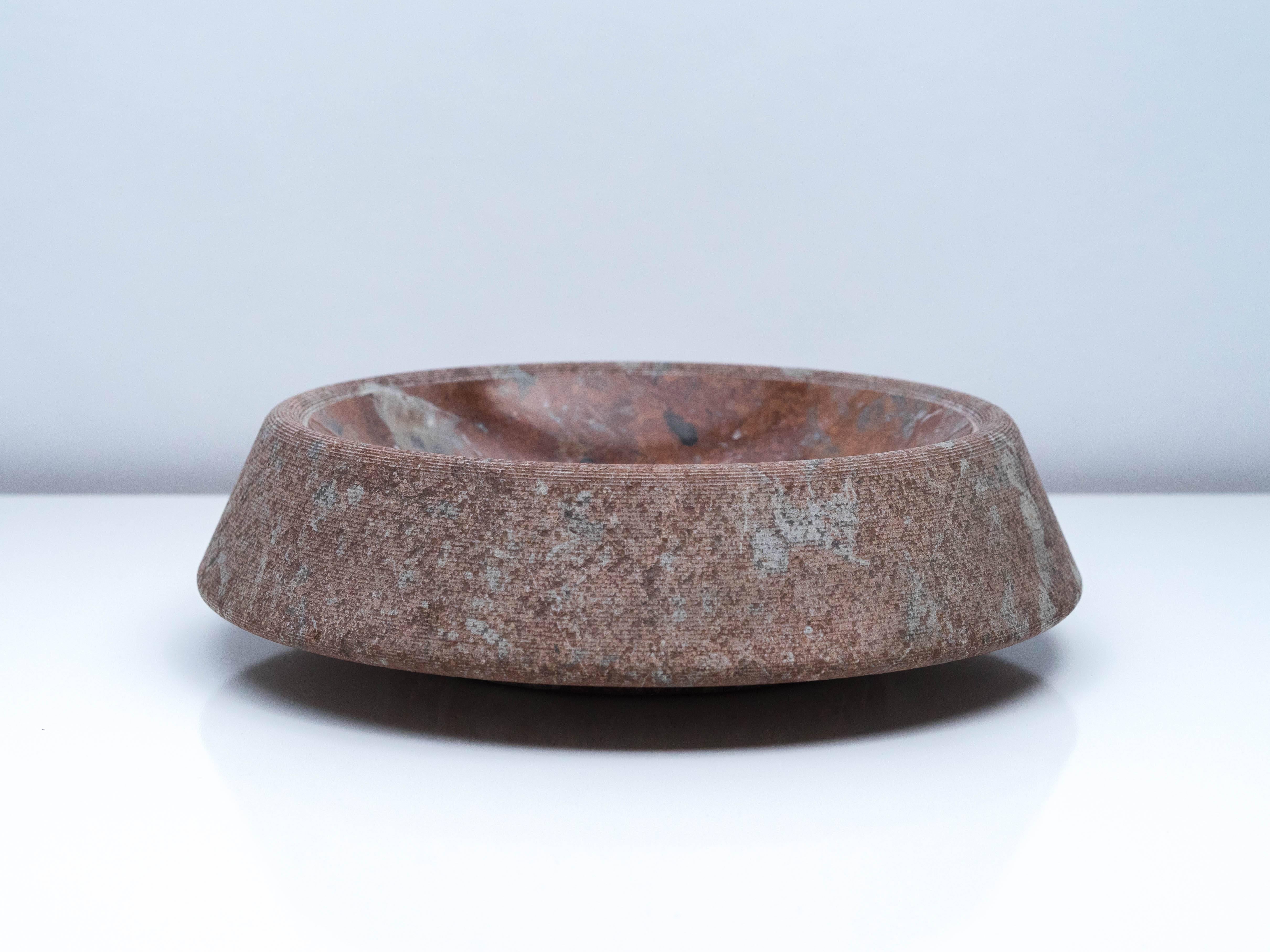 A large and impressive centrepiece designed by Giancarlo Cacciatori and produced by Italian stone specialists Up & Up in the 1970s. The red ochre and white-veined red Bilbao limestone bowl sits atop an inch-high support, giving the impression that