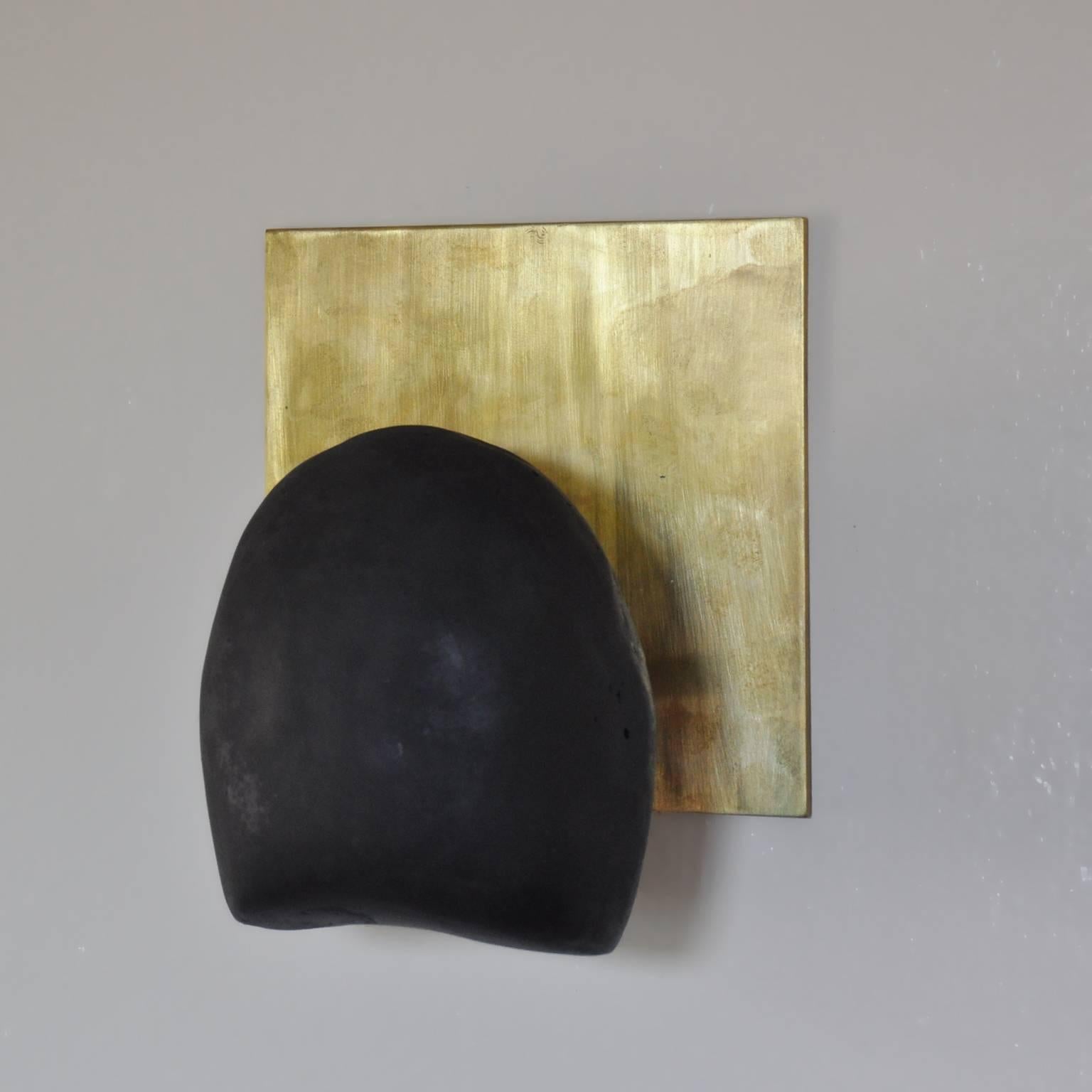 The Tallomet 01 Sconce is made of a hand-cast black concrete shell post-mounted onto a 1/8" patinated brass backplate. Available hard-wired or with cord and in-line rocker switch, this sconce ships with two LED bulbs and emits a soft glow.