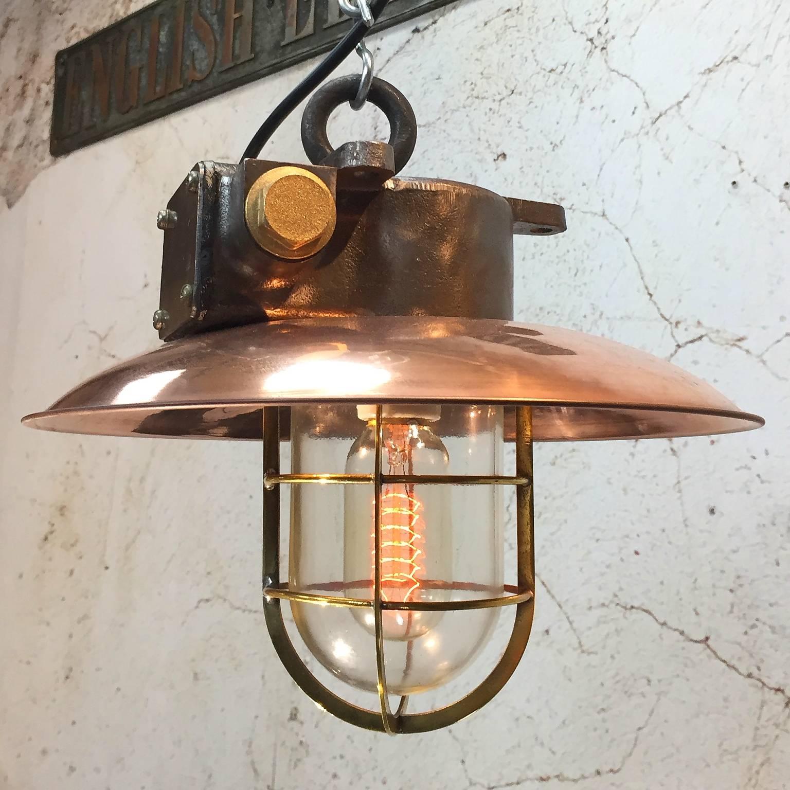 Iron explosion proof pendant with 30 cm copper shade E27.

Cast iron and glass. Sold without chain and S-hook.

This excellent example of an original explosion proof lamp which was salvaged from an old German ship. The date is circa 1975, it has