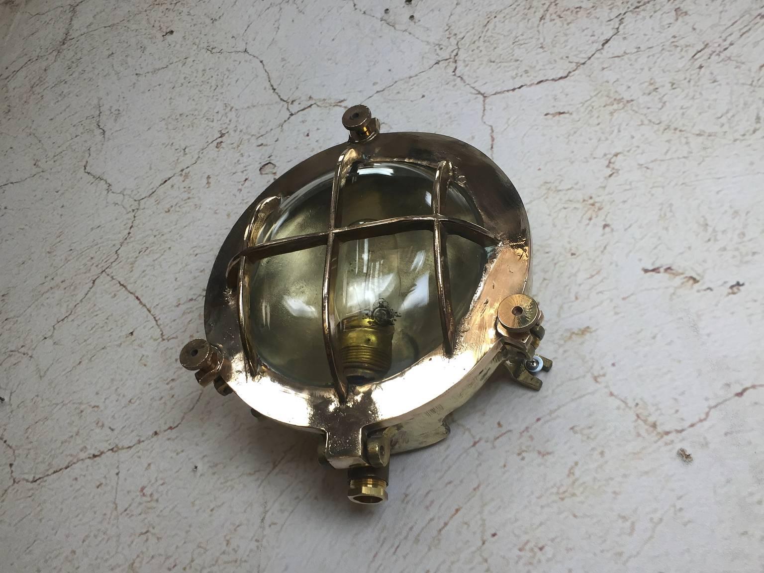 German made circa 1970.

Very heavy cast fittings made for super tankers and cargo ships.

The caged front is the bronze section and the body is brass cast.

These lights have great presence and are a real statement in their