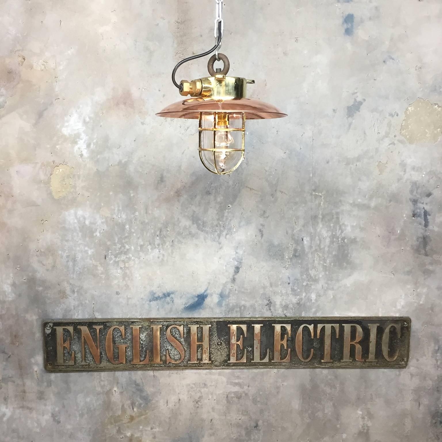Solid brass explosion proof pendant with copper shade. This excellent example of an original explosion proof lamp which was salvaged from an old Japanese cargo ship circa 1977. The body and cage are both cast, with glass dome and spun shade. A very