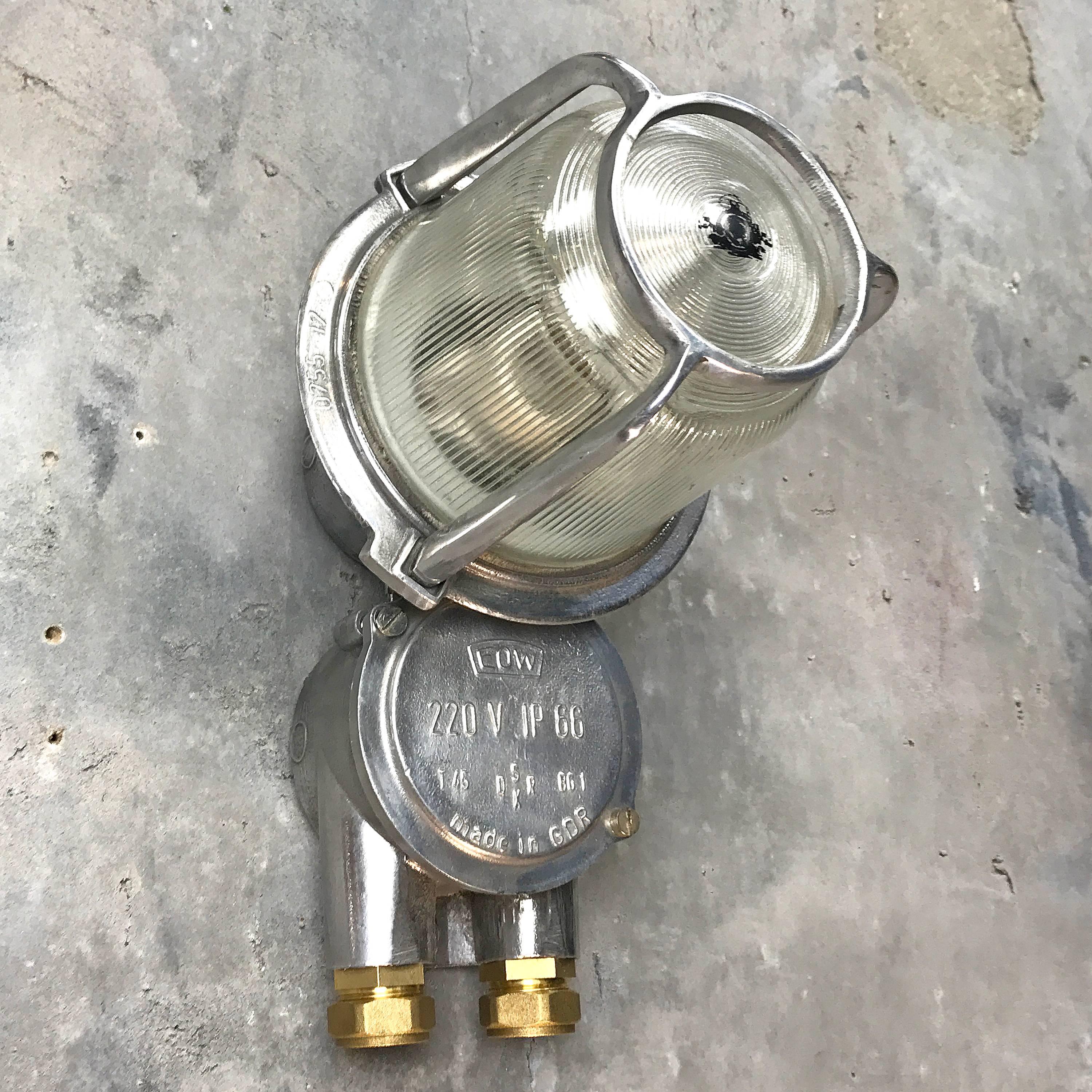 These lights are reclaimed from old super tankers and cargo ships.
The glass is clamped down by the cast frame, the frame and the glass turn and detach to reveal the lamp.
Loomlight has added the brass compression fittings to create a new gland
